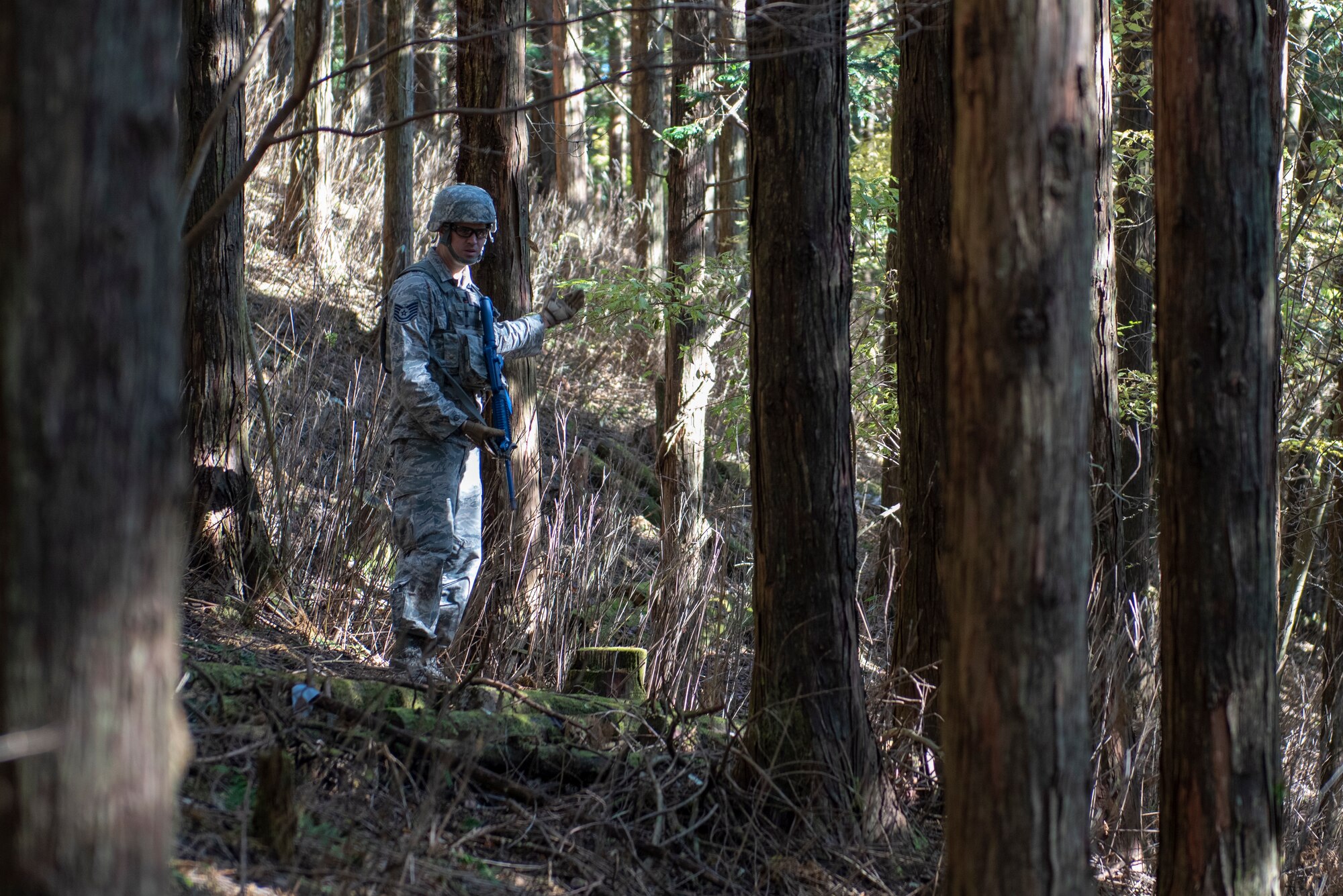 U.S. Air Force Tech. Sgt. Justin Hamilton, 374th Security Forces Squadron flight chief, motions to his team to follow during a field training exercise at Camp Fuji, Japan, Nov. 8, 2018.