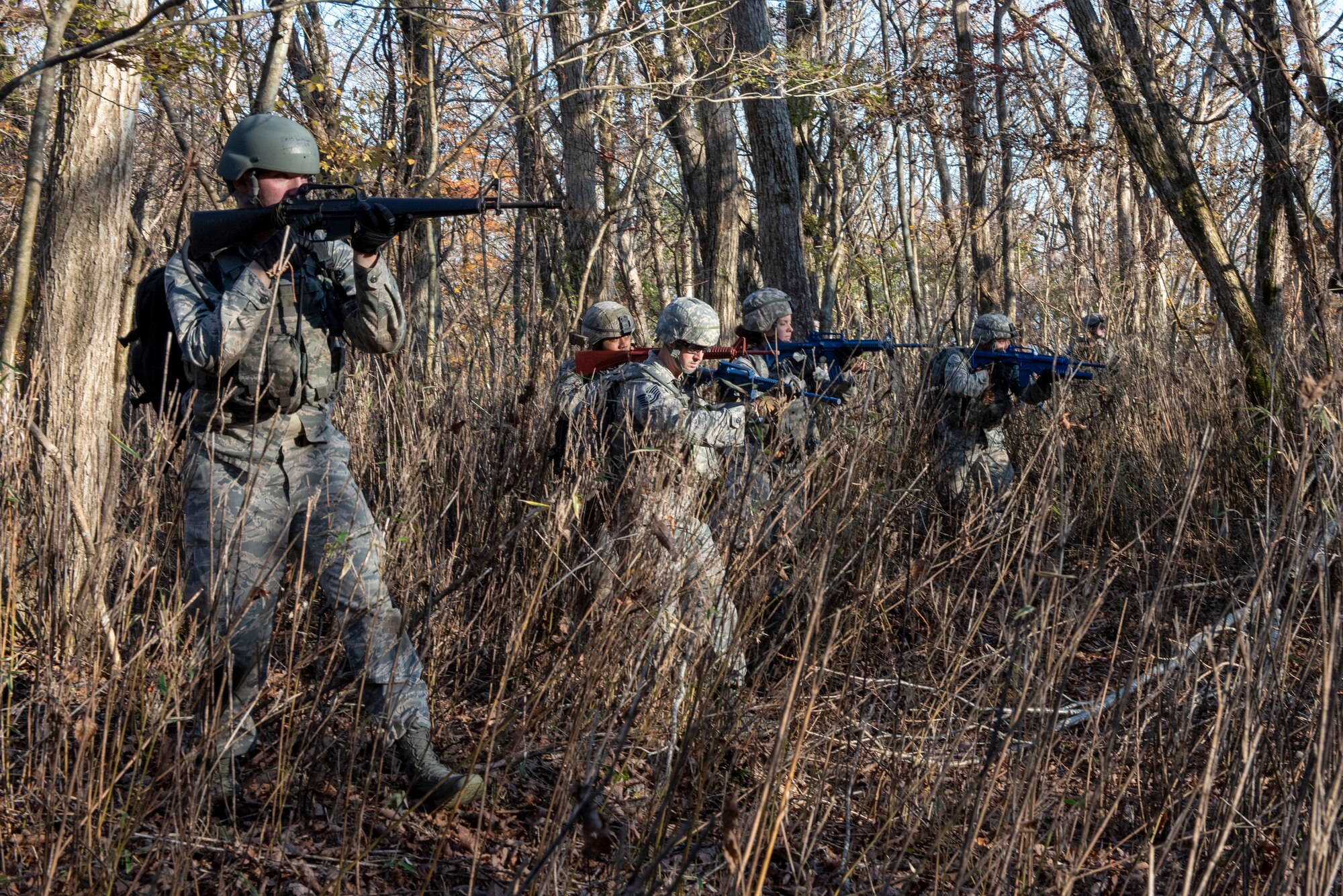 Airmen from the 374th Security Forces Squadron advance together to sweep an area prior to completing their final mission objective during a field training exercise at Camp Fuji, Japan, Nov. 8, 2018.