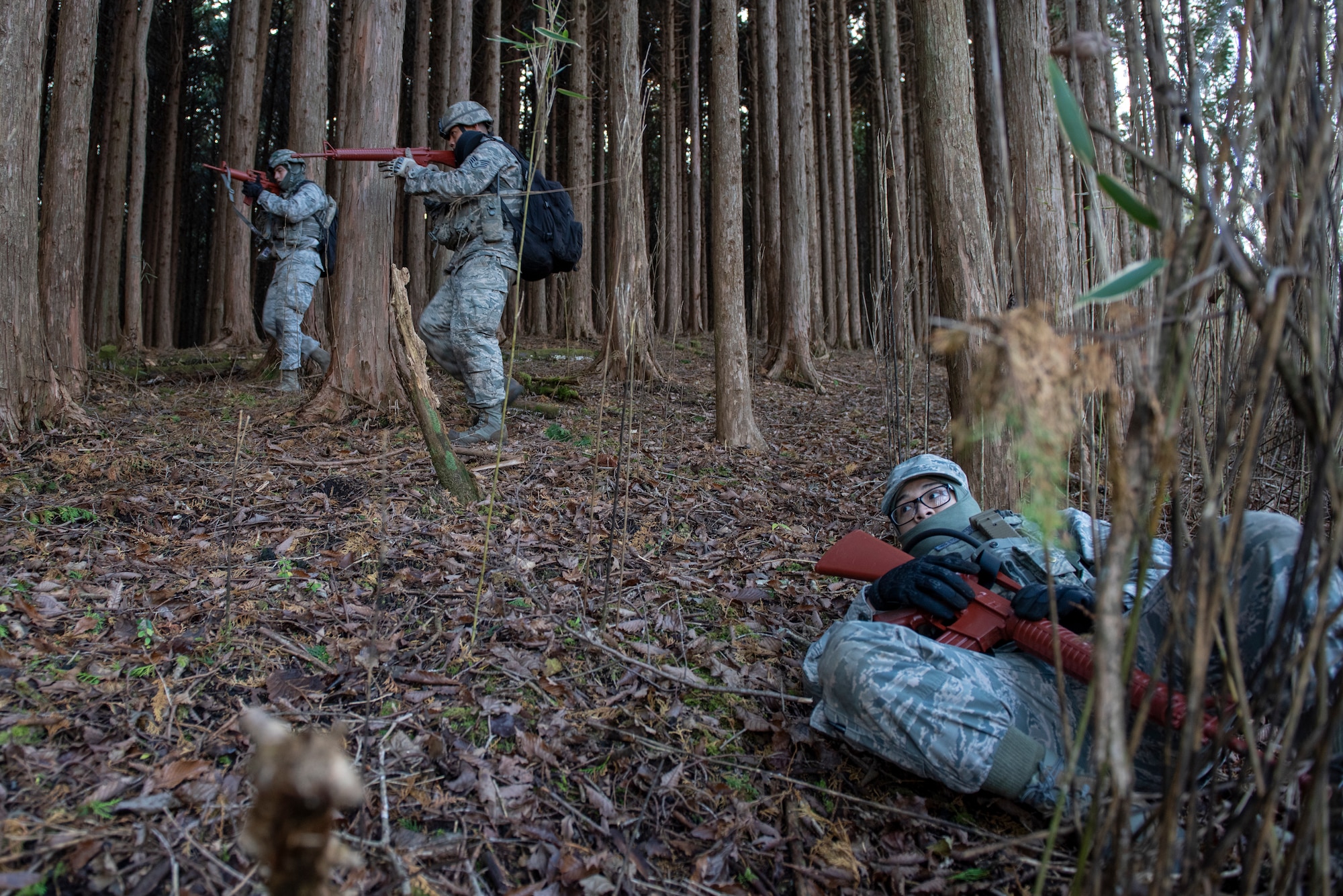 Airmen with the 374th Security Forces Squadron, top left, complete a sweep as a simulated enemy lays defeated on the right during a field training exercise at Camp Fuji, Japan, Nov. 8, 2018.