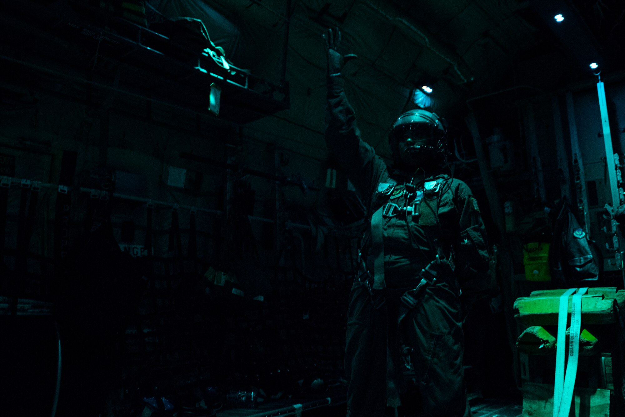 U.S. Air Force Staff Sgt. Crystal Reese, 37th Airlift Squadron C-130J Super Hercules loadmaster, stands ready to conduct a cargo delivery system equipment drop during a nighttime sortie over a drop zone in Germany, Nov. 8, 2018. Reese was responsible for verifying the cargo left the aircraft without issue and at the allotted time. (U.S. Air Force photo by Senior Airman Devin M. Rumbaugh)