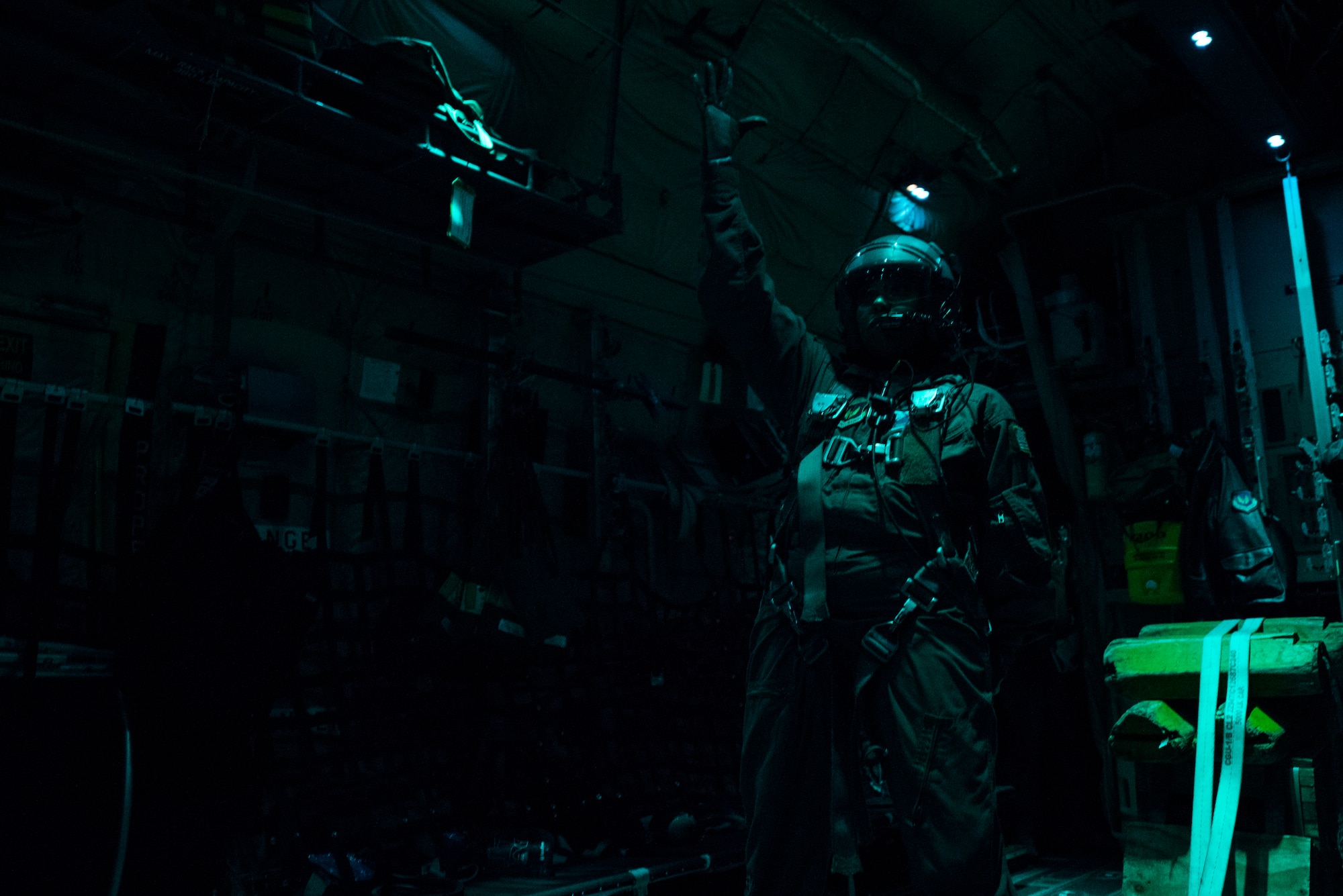 U.S. Air Force Staff Sgt. Crystal Reese, 37th Airlift Squadron C-130J Super Hercules loadmaster, stands ready to conduct a cargo delivery system equipment drop during a nighttime sortie over a drop zone in Germany, Nov. 8, 2018. Reese was responsible for verifying the cargo left the aircraft without issue and at the allotted time. (U.S. Air Force photo by Senior Airman Devin M. Rumbaugh)