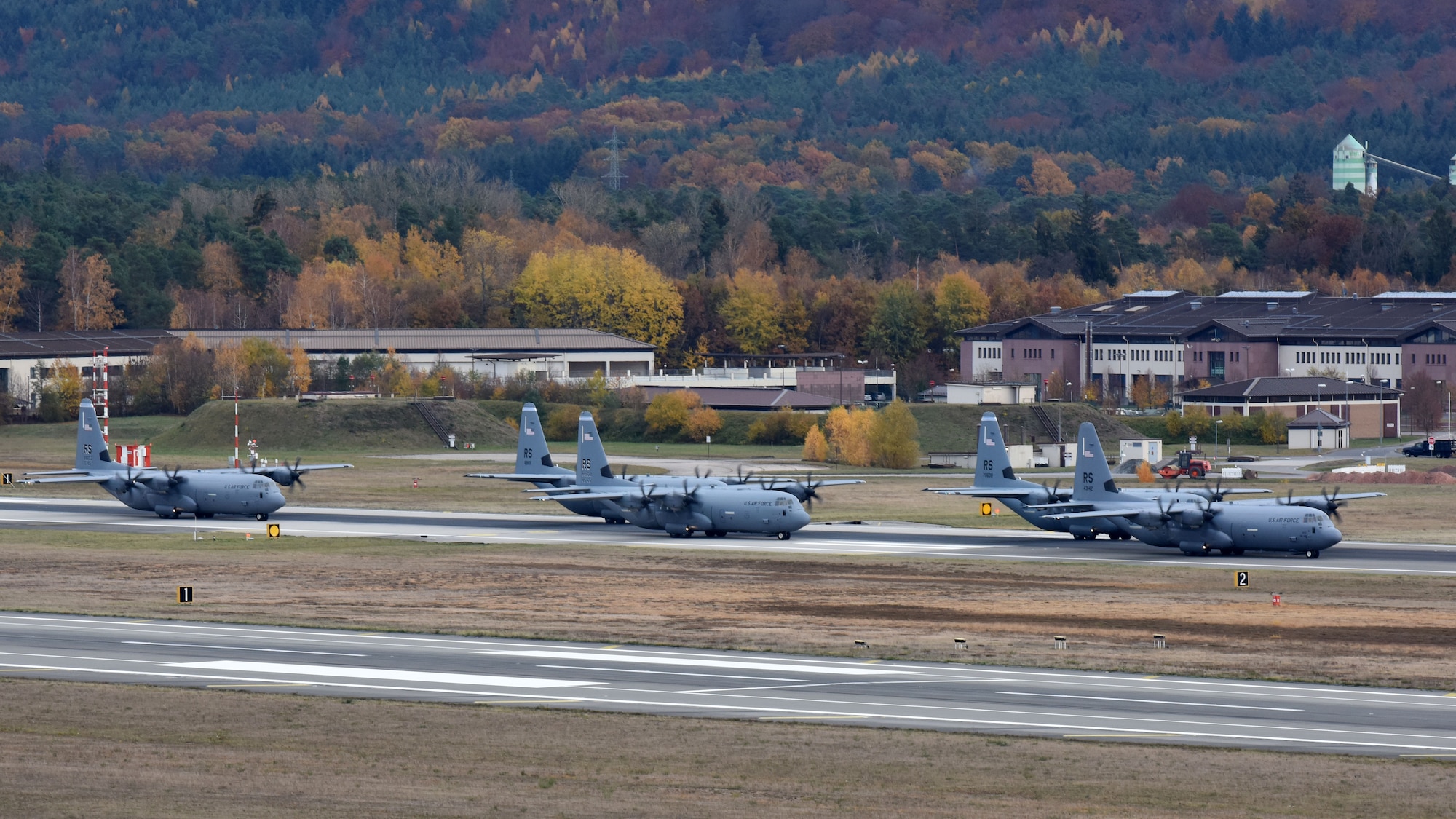 U.S. Air Force C-130J Super Hercules aircraft line up on the runway for an elephant walk on Ramstein Air Base, Germany, Nov. 8, 2018. The elephant walk was part of a mass generation exercise held by the 86th Airlift Wing. (U.S. Air Force photo by Airman 1st Class Milton Hamilton)