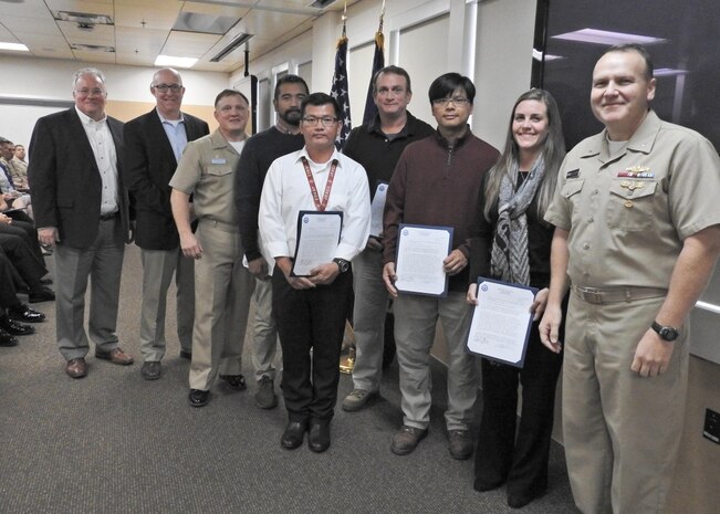 PANAMA CITY, Florida - Commander, Naval Surface Warfare Center (NSWC) Rear Adm. Tom Anderson and Warfare Center Executive Director Don McCormack (SES) present the Joint Expeditionary Command and Control team letters of appreciation Nov. 15, 2018 for their dedication and support to NSWC PCD reconstitution during the aftermath of Hurricane Michael. Recipients are as follows: Jason Calzado, Richard Childress, Jim Nelson, Chiyan Ng, Vinh Tran, Lisa Winsett. U.S. Navy photo by Susan H. Lawson