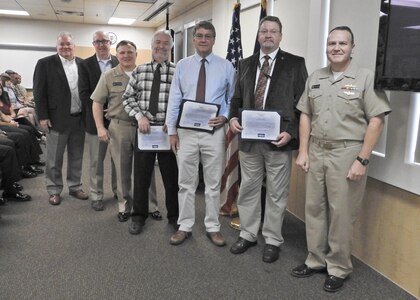 PANAMA CITY, Florida - Commander, Naval Surface Warfare Center (NSWC) Rear Adm. Tom Anderson and Warfare Center Executive Director Don McCormack (SES) present Special Act Awards to three employees Nov. 15, 2018 for their dedication and support during the aftermath and reconstitution of NSWC PCD from Hurricane Michael. Award recipients are as follows: Don McCall, Bill Logsdon, and Kendal Smith. U.S. Navy photo by Susan H. Lawson