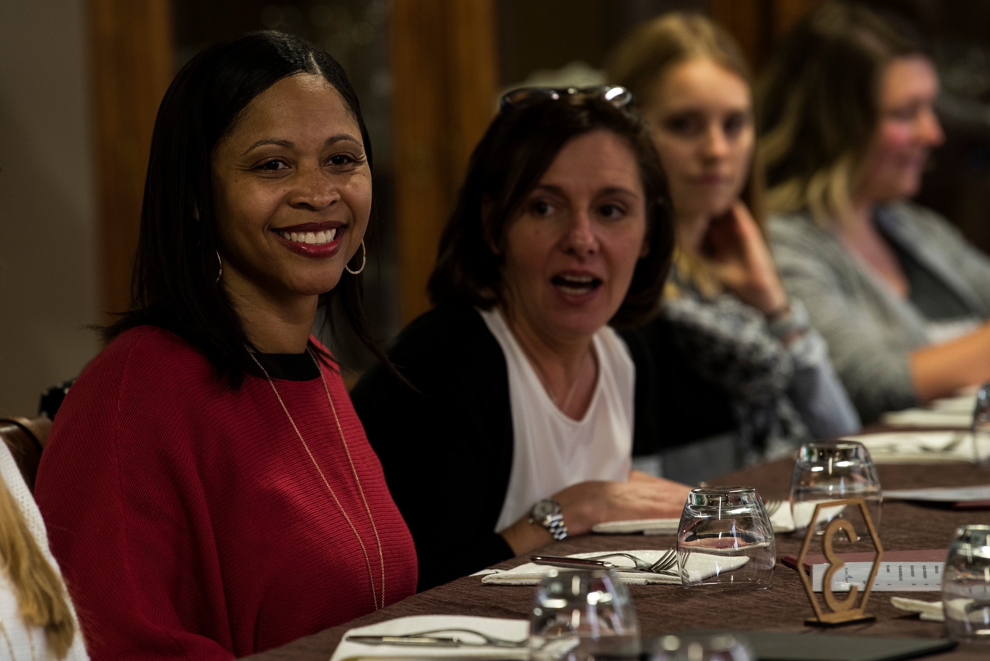 Tanquer Dyer, wife of U.S. Air Force Chief Master Sgt. Alvin Dyer, 52nd Fighter Wing command chief, front, meets with military spouses at Ghedi Air Base, Italy, Nov. 15, 2018. Leadership from Spangdahlem Air Base, Germany, visited the 704th Munitions Support Squadron, one of the nine 52nd FW geographically separated units. Spouse visits help build community and support between GSUs. (U.S. Air Force photo by Airman 1st Class Valerie Seelye)