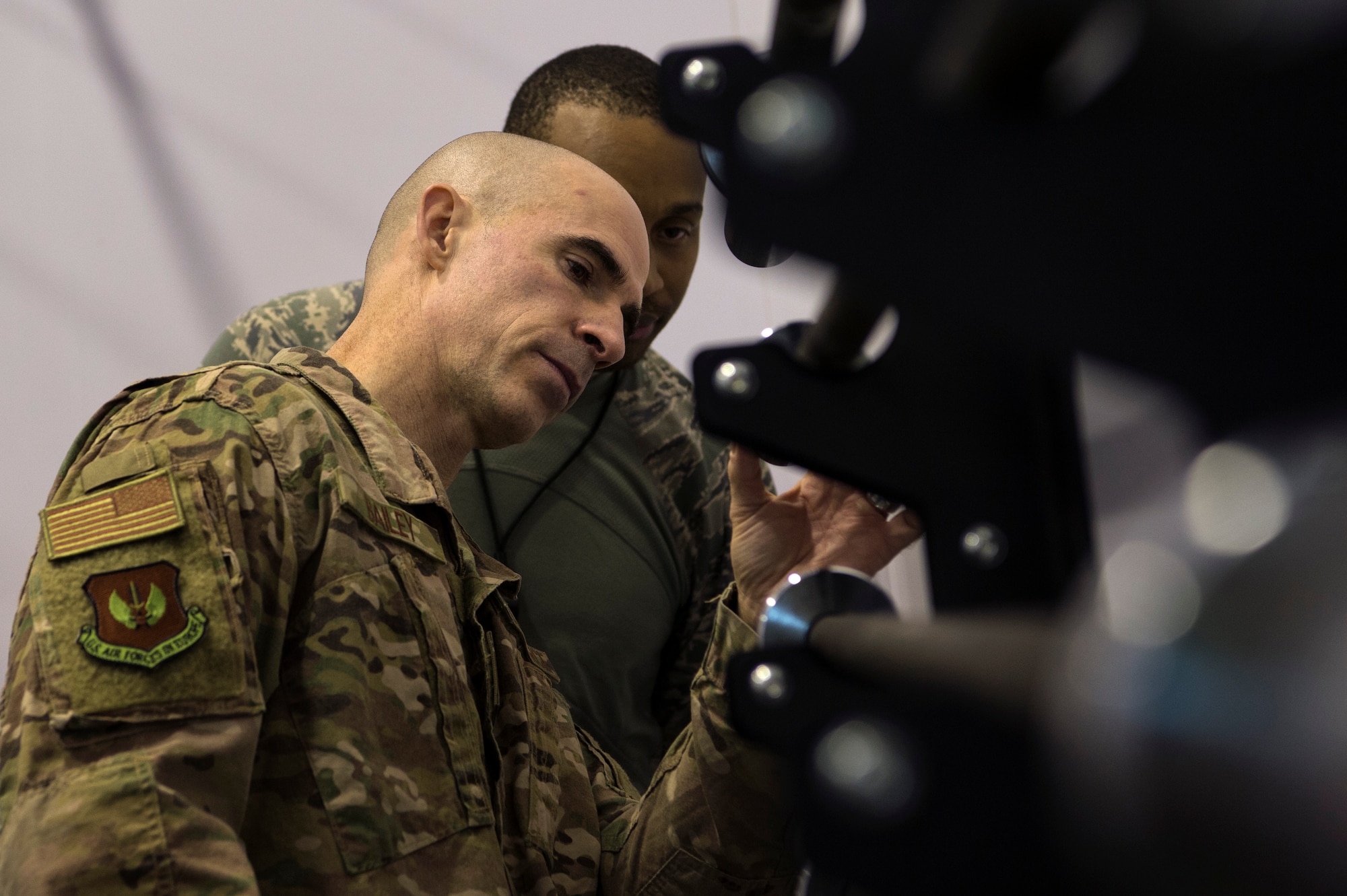 U.S. Air Force Col. Jason Bailey, 52nd Fighter Wing commander, front, tours the fitness center at Ghedi Air Base, Italy, Nov. 15, 2018. Senior Airman Daniel Coleman, 704th Munitions Support Squadron fitness specialist, back, demonstrated the center's new equipment. Leadership from Spangdahlem Air Base, Germany, visited the 704th MUNSS to support and connect with Airmen. (U.S. Air Force photo by Airman 1st Class Valerie Seelye)