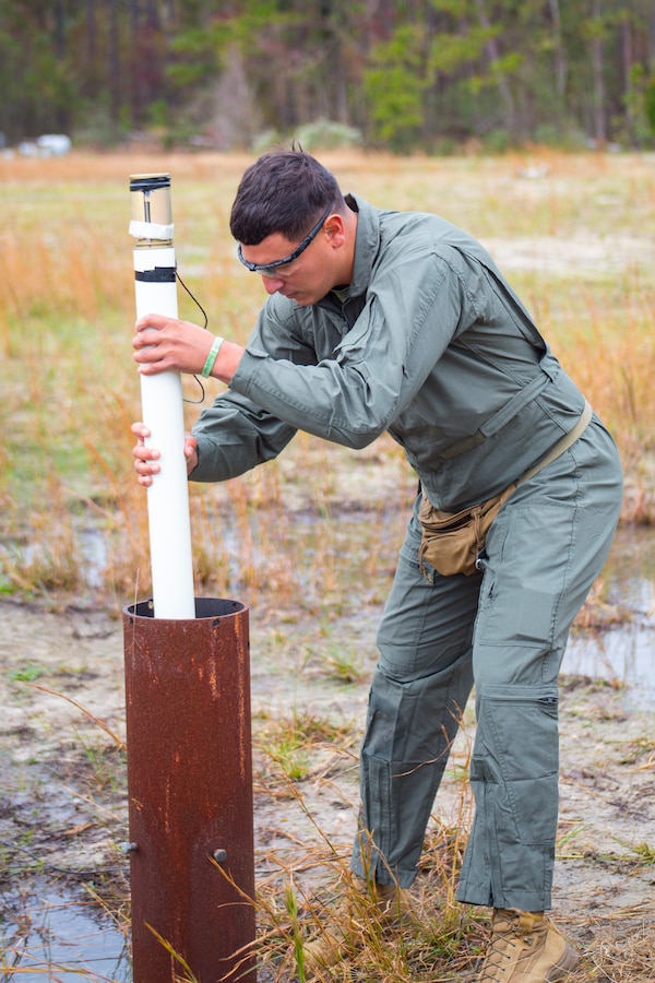 U.S. Marine Corps Sgt. Benjamin Montoya, an Explosive Ordnance Disposal technician, places a 2 1/2 inch rocket into a tube during a static-fire range operations at Marine Corps Air Station Cherry Point, N.C., Nov. 14, 2018. In total, six rocket engines were used during the EOD annual training exercise. During the training, EOD technicians removed explosives from the rockets, allowing them to be used safely in future demonstrations. In addition to the annual training, the Marines also conduct live-fire and static-fire range operations on a bi-weekly to monthly basis. Montoya is assigned to Marine Wing Support Squadron 271, Marine Wing Support Group 27, 2nd Marine Aircraft Wing. (U.S. Marine Corps photo by Lance Cpl. Andrew King)