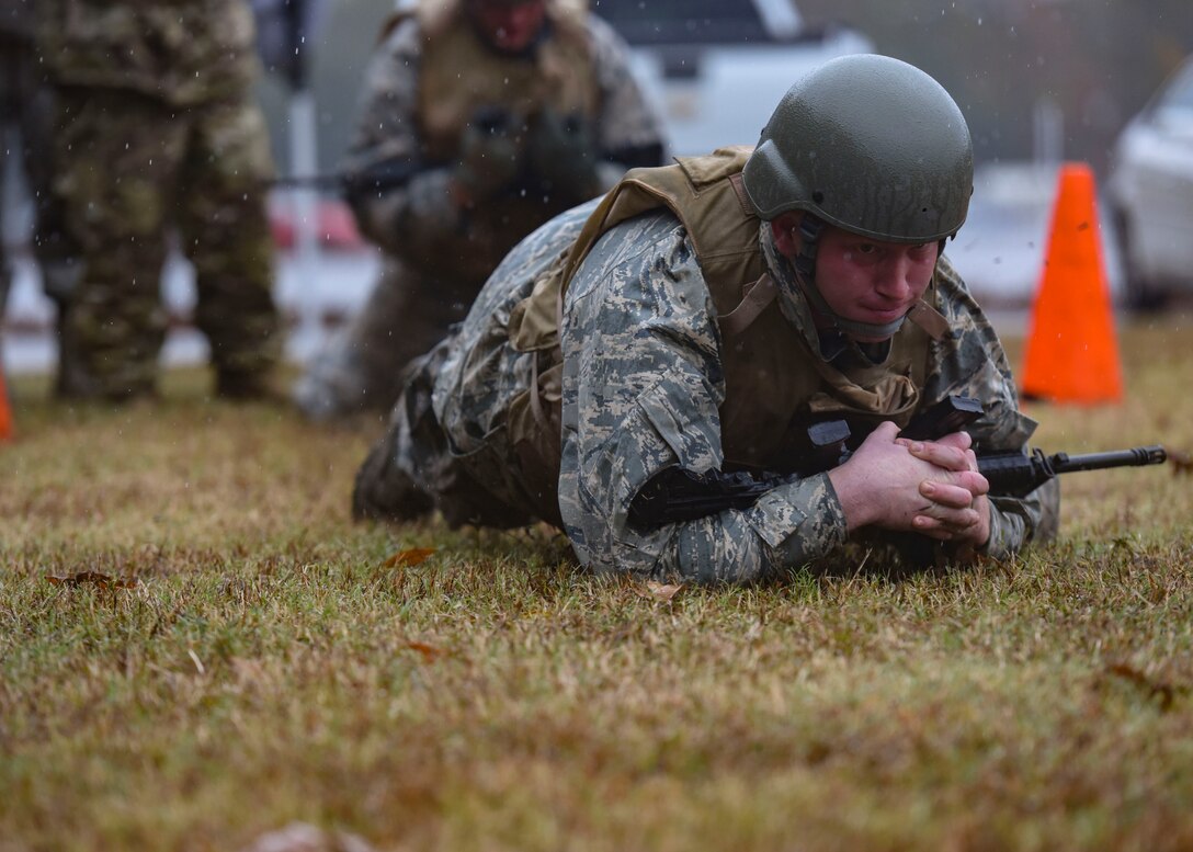 U.S. Air Force Senior Airman Cody Smitherman, 633rd Civil Engineer Squadron electrical systems apprentice, crawls with his weapon during Prime Base Engineer Emergency Force training at Joint Base Langley-Eustis, Virginia, Nov. 15, 2018.