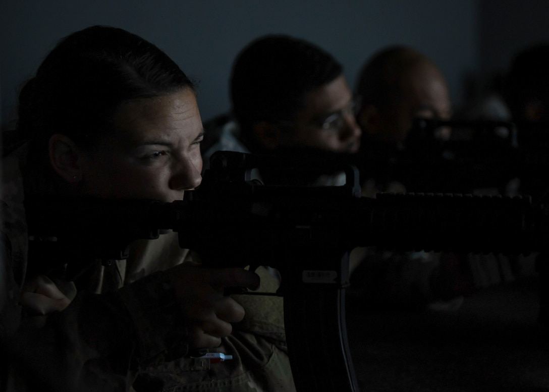 U.S. Air Force Senior Airman Lauren Lane, 633rd Civil Engineer Squadron heating, ventilation and air conditioning technician, takes aim during a simulated firing exercise at Joint Base Langley-Eustis, Virginia, Nov. 15, 2018.