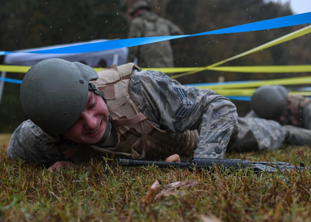 U.S. Air Force Senior Airman Brandon Ambrose, 633rd Civil Engineer Squadron electrical systems journeyman, performs a low crawl during Prime Base Engineer Emergency Force training at Joint Base Langley-Eustis, Virginia, Nov. 15, 2018.