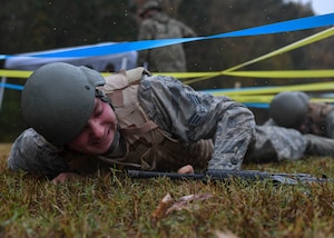 U.S. Air Force Senior Airman Brandon Ambrose, 633rd Civil Engineer Squadron electrical systems journeyman, performs a low crawl during Prime Base Engineer Emergency Force training at Joint Base Langley-Eustis, Virginia, Nov. 15, 2018.