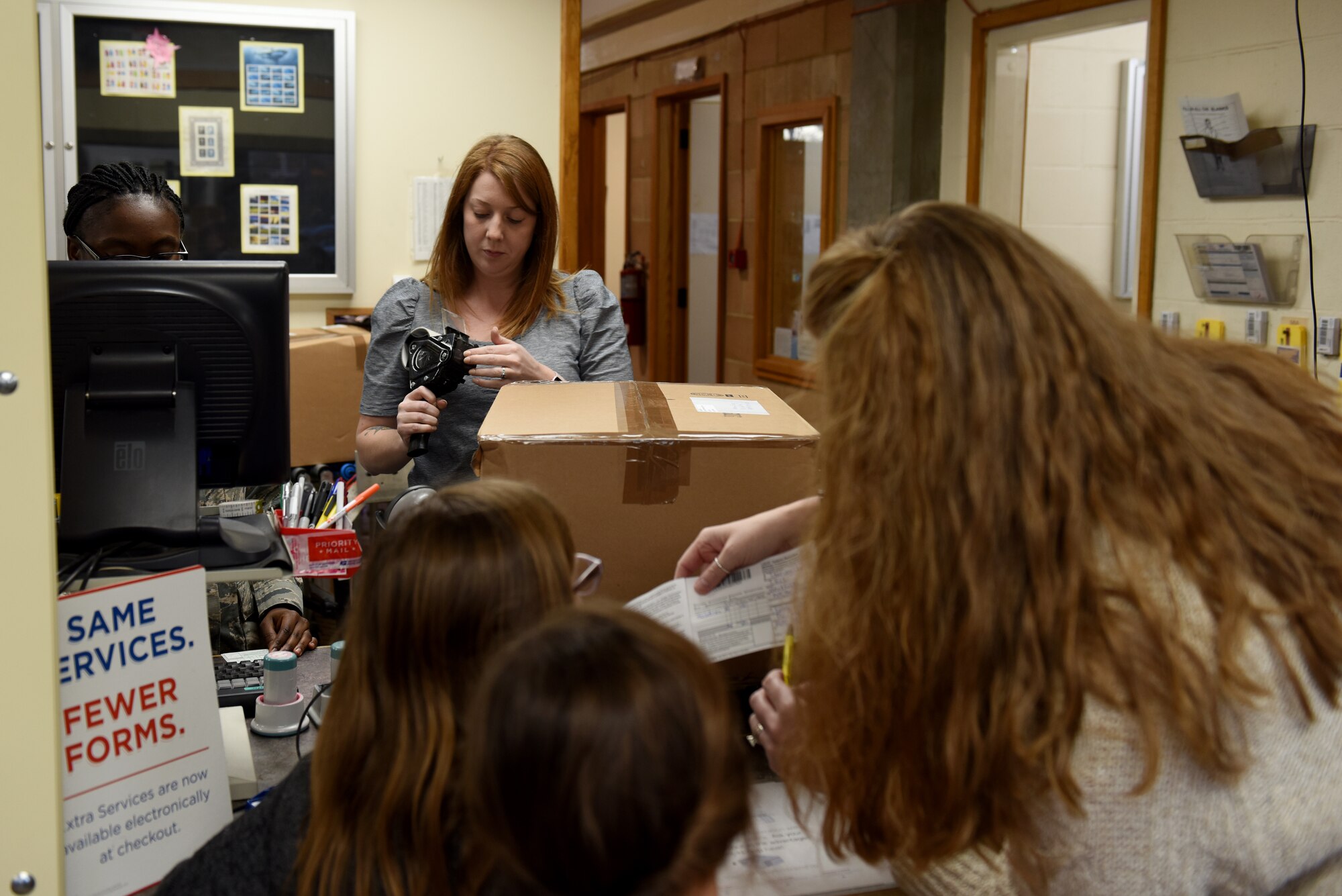 Students from Liberty Intermediate School drop care packages off at the post office at Royal Air Force Lakenheath, England, Nov. 13, 2018. From October 17 to November 12, students from the National Elementary Honors Society and Continuous School Improvement juniors collected supplies for deployed Liberty Wing security forces members and firefighters. (U.S. Air Force photo by Senior Airman John A. Crawford)