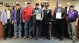 Twelve veterans and a Soldier in uniform at induction ceremony.