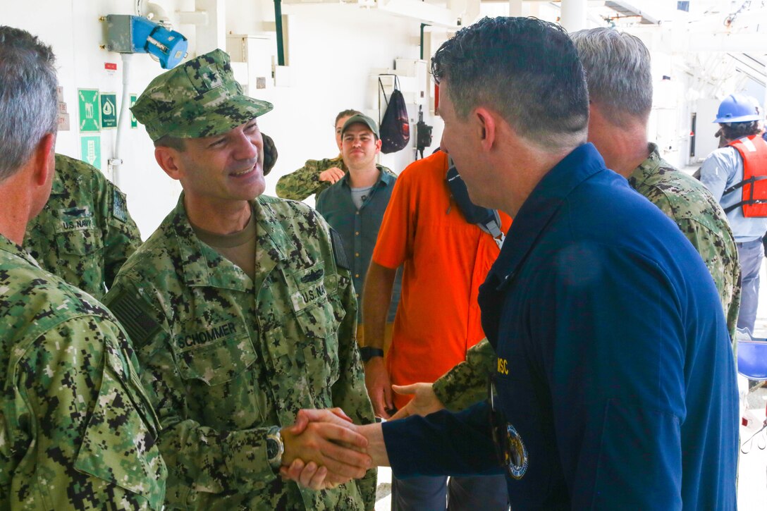 Rear Adm. John Schommer, deputy commander, U.S. 4th Fleet, arrives aboard the hospital ship USNS Comfort (T-AH 20) and meets with Merchant Marine Capt. David Murrin, ship’s master, Comfort.