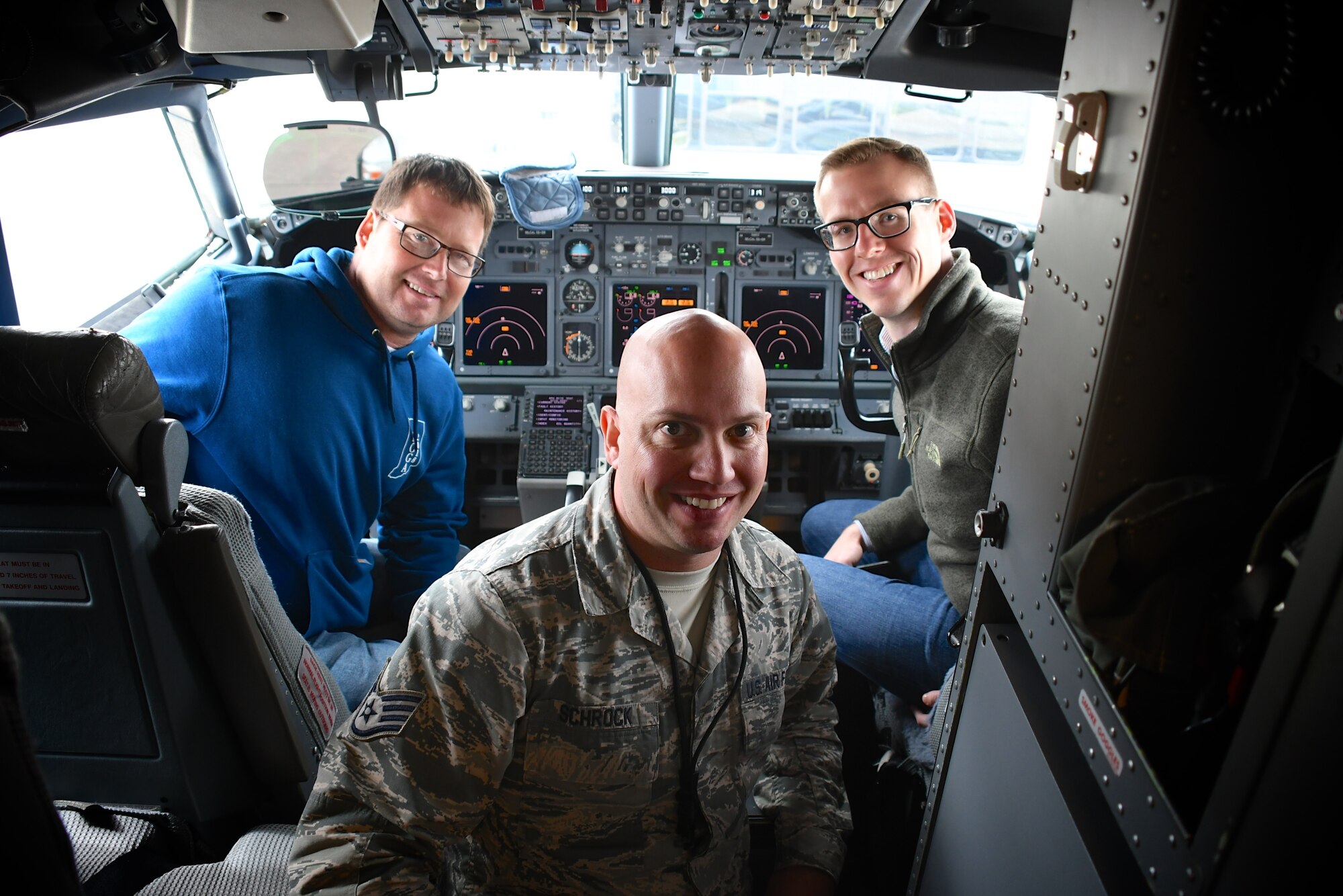 Employers sit inside the cockpit of a C-40 plane and talk to the 932nd Maintenance Group's Staff Sgt. Jeremy Schrock, part of the maintenance crew taking care of the aircraft during the annual Boss Day visitation event hosted by the 932nd Airlift Wing October 13, 2018, at Scott Air Force Base, Illinois. Civilian employers also saw medical reservists training, security forces and equipment demos from 932nd Explosive Ordnance Disposal (EOD) and met civil engineers and firefighters. The 932nd AW provides world-class, reliable airlift for the nation's civilian and military leaders.(U.S. Air Force photo by Lt. Col. Stan Paregien)