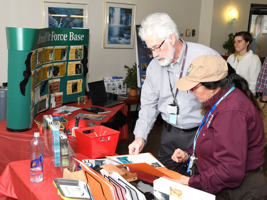 As part of an outreach effort during International Bat Week held Oct. 24-31, Leslie Hay, U.S. Fish and Wildlife Service liaison at Arnold Air Force Base, hands out informational packets at Café 100 in the Administration and Engineering Building on Oct. 31. Pictured is Hay, right, with Maurice May. (U.S. Air Force photo by Rick Goodfriend)