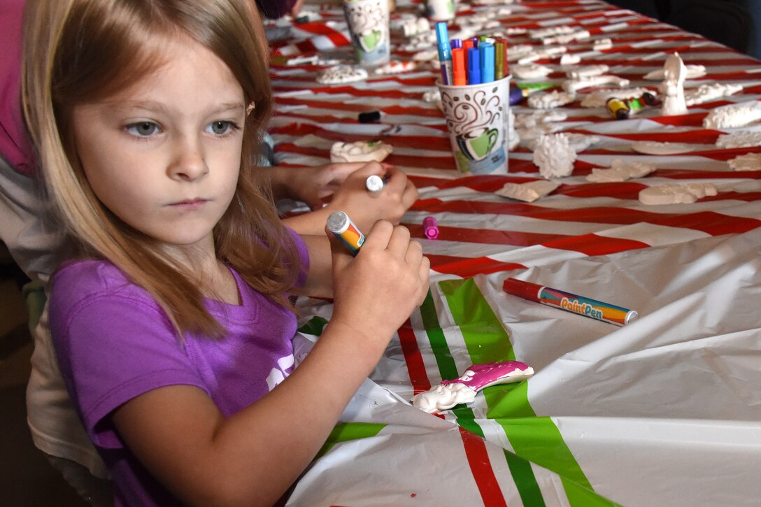 Mikayla, an attendee at the 38th Annual Santa’s Market, takes advantage of an ornament decorating station in the Louis F. Garland Department of Defense Fire Academy on Goodfellow Air Force Base, Texas, Nov. 17, 2018. After decorating their ornaments the children were able to take them home. (U.S. Air Force photo by Airman 1st Class Seraiah Hines/Released)
