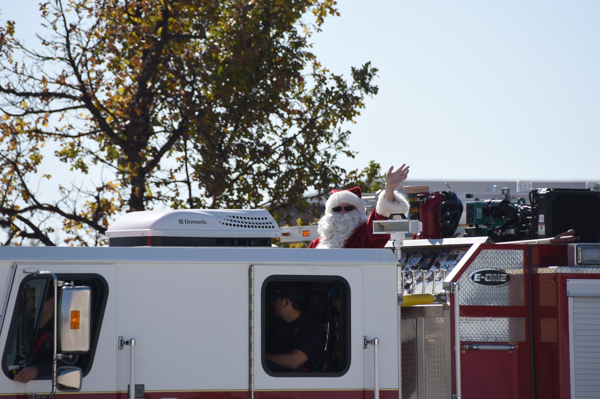 Santa Clause waves from a fire truck as he arrives at Santa’s Market held at the Louis F. Garland Department of Defense Fire Academy on Goodfellow Air Force Base, Texas, Nov. 17, 2018. Santa’s Market is an annual event, held since 1980, that allows community members to come on base to shop from a variety of local vendors. (U.S. Air Force photo by Airman 1st Class Seraiah Hines/Released)