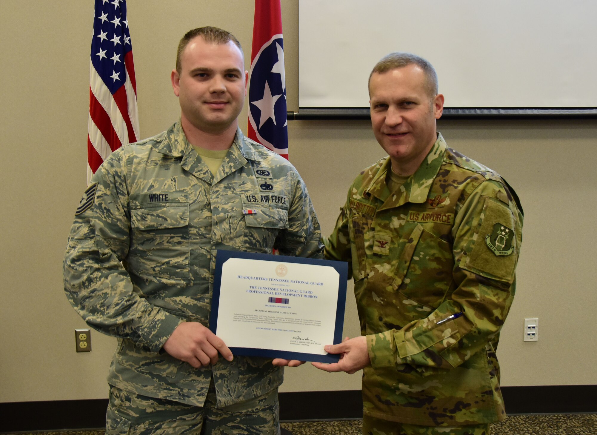 U.S. Air National Guard Tech. Sgt. David White, an occupational safety Airman with the 118th Wing Safety Office, is awarded the professional development ribbon by Col. Keith Allbritten, commander of the 118th Wing, on Nov. 3, 2018 at Berry Field Air National Guard Base, Nashville, Tennessee.