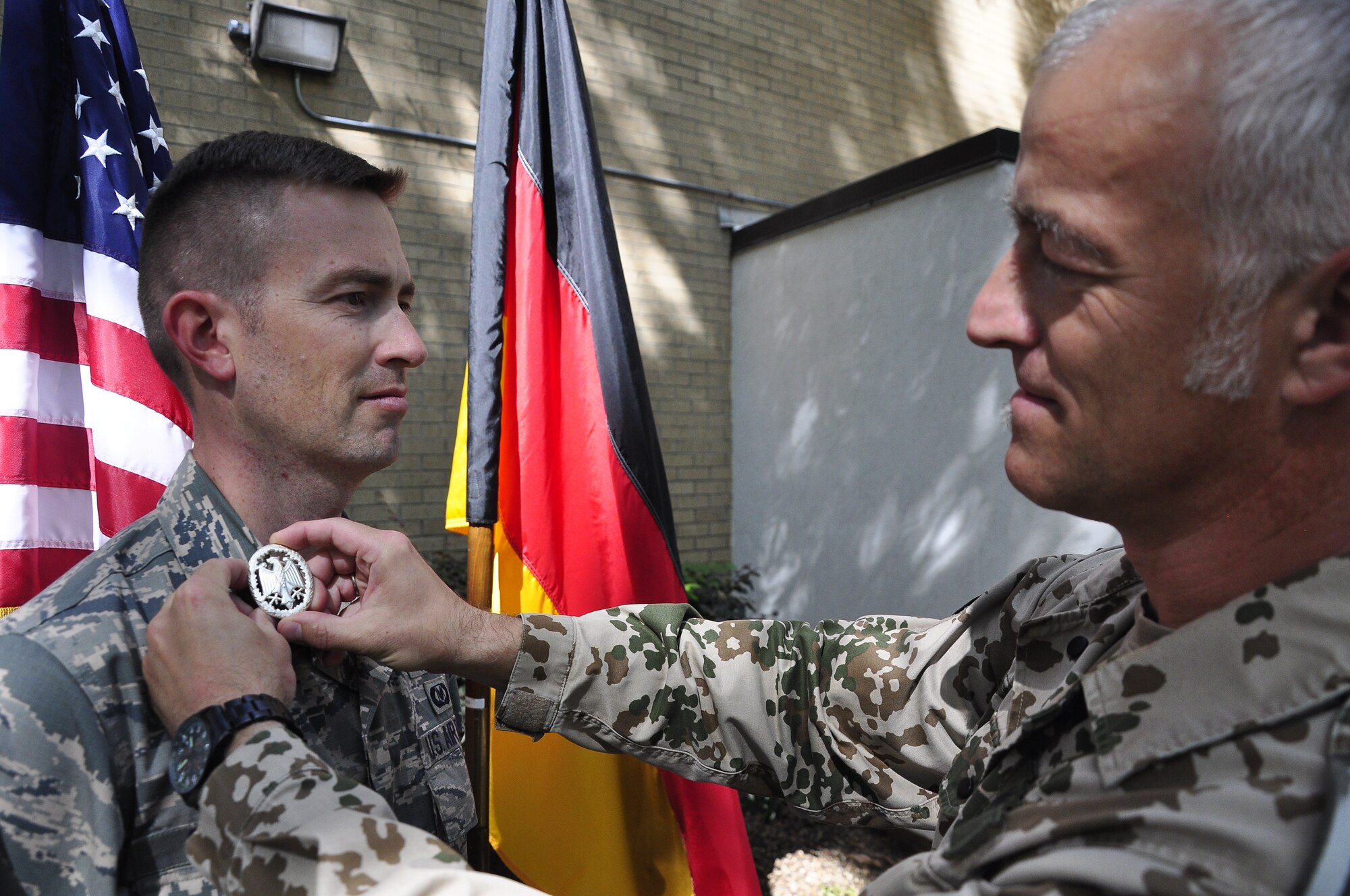 Maj George Chapman, Air Command and Staff College student, receives a German Armed Forces Proficiency Badge from German liaison officer SgtMaj Michael Kern at Maxwell's Air War College on May 4th