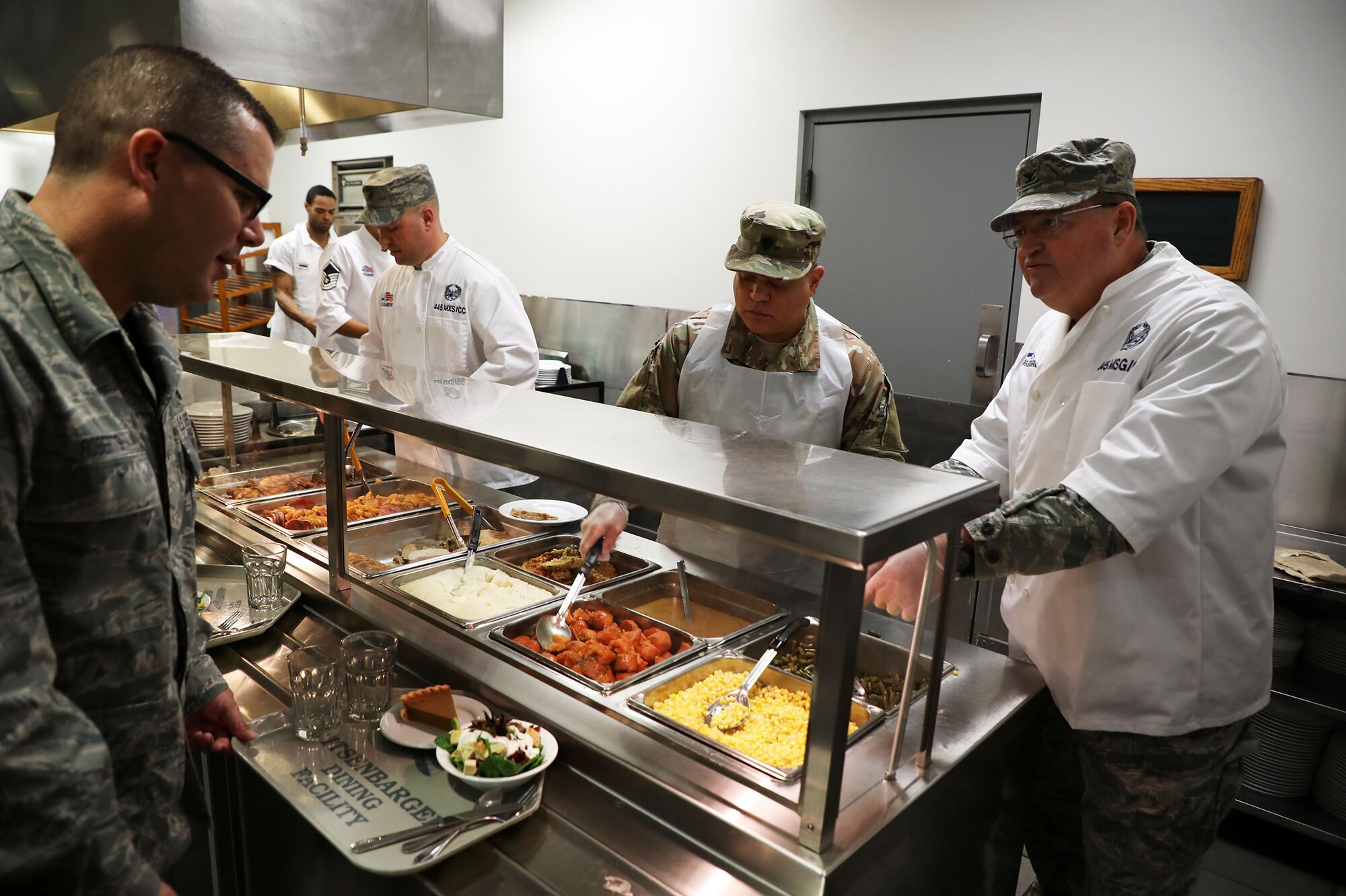 Col. Bryan Runion, 445th Mission Support Group commander, Lt. Col. John Marang,445th MSG deputy commander and Senior Master Sgt. Eric Rine, 445th Maintenance Squadron first sergeant, serve holiday meals to 445th AW Airmen at the Pitsenbarger Dining Facility Nov. 4, 2018. Each year, commanders, chiefs and first sergeants serve meals to Airmen during the November and December unit training assemblies