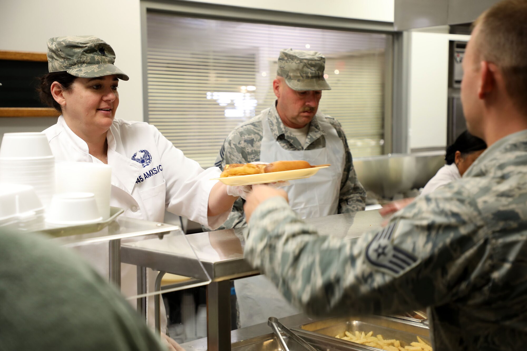 Lt. Col. Susanne Dean 445th Aircraft Maintenance Squadron commander and Chief Master Sgt. Mark Lockhart, 445th Maintenance Group superintendent, serve lunch to 445th AW Airmen at the Pitsenbarger Dining Facility Nov. 4, 2018. Each year, commanders, chiefs and first sergeants serve meals to Airmen during the November and December unit training assemblies.