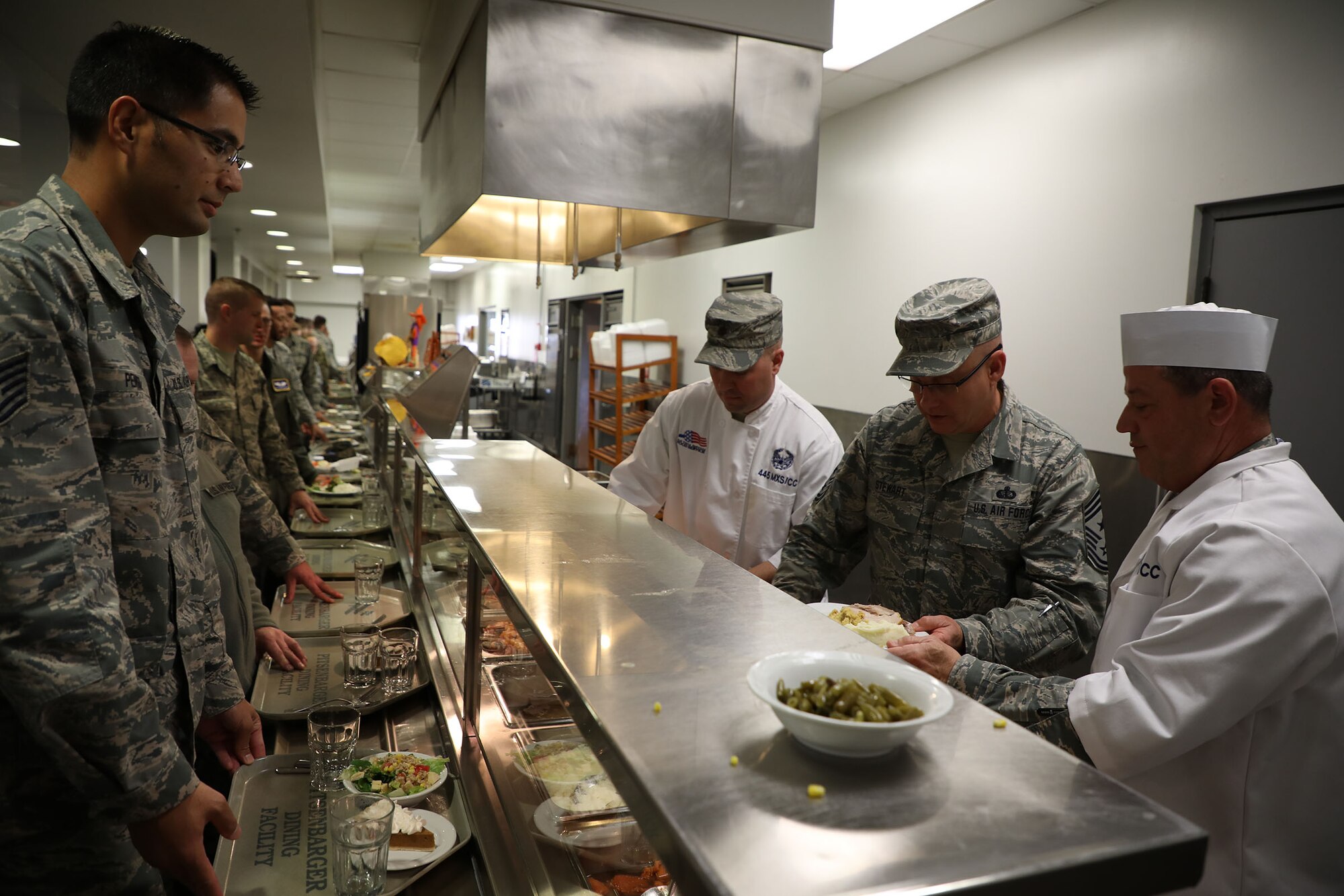 Col. Adam Willis, 445th Airlift Wing commander, Chief Master Sgt. Paul Stewart, 445th command chief and Lt. Col. Todd Reeder, 445th Maintenance Squadron, serve holiday meals to 445th AW Airmen at the Pitsenbarger Dining Facility Nov. 4, 2018. Each year, commanders, chiefs and first sergeants serve meals to Airmen during the November and December unit training assemblies.