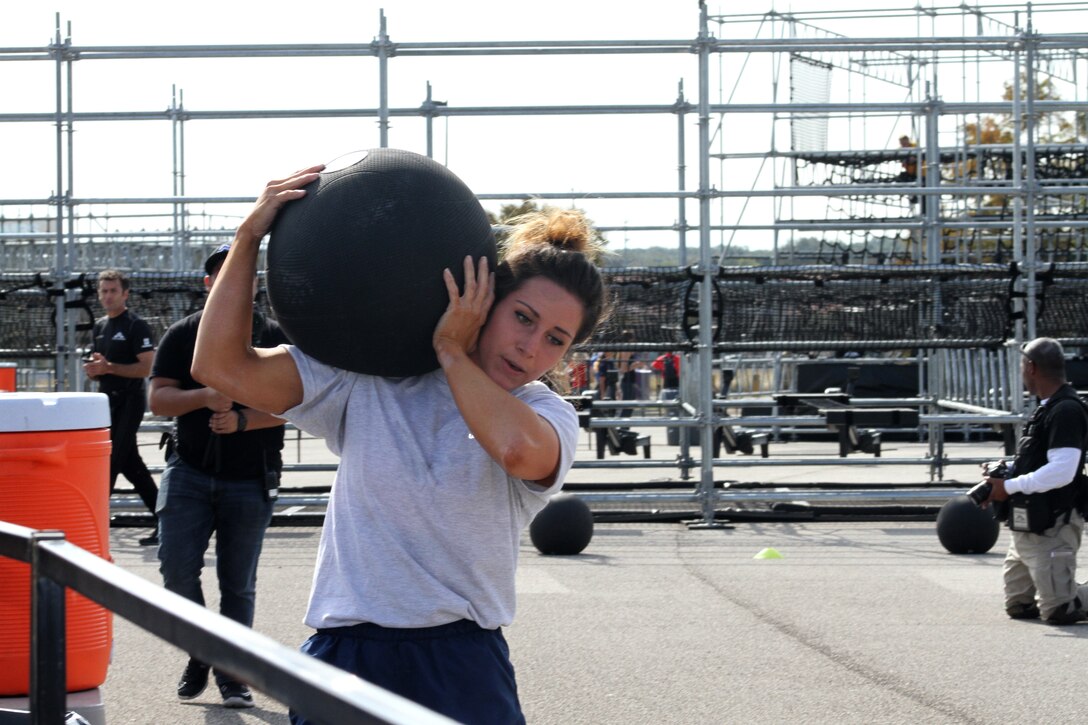Air Force Senior Airman Stephanie Williams carries a medicine ball during one of the strength stations of the proving rig during the first Inter-service Alpha Warrior Final Battle Nov. 17, 2018, Retama Park, Selma, Texas. (U.S. Air Force photo by Debbie Aragon)
