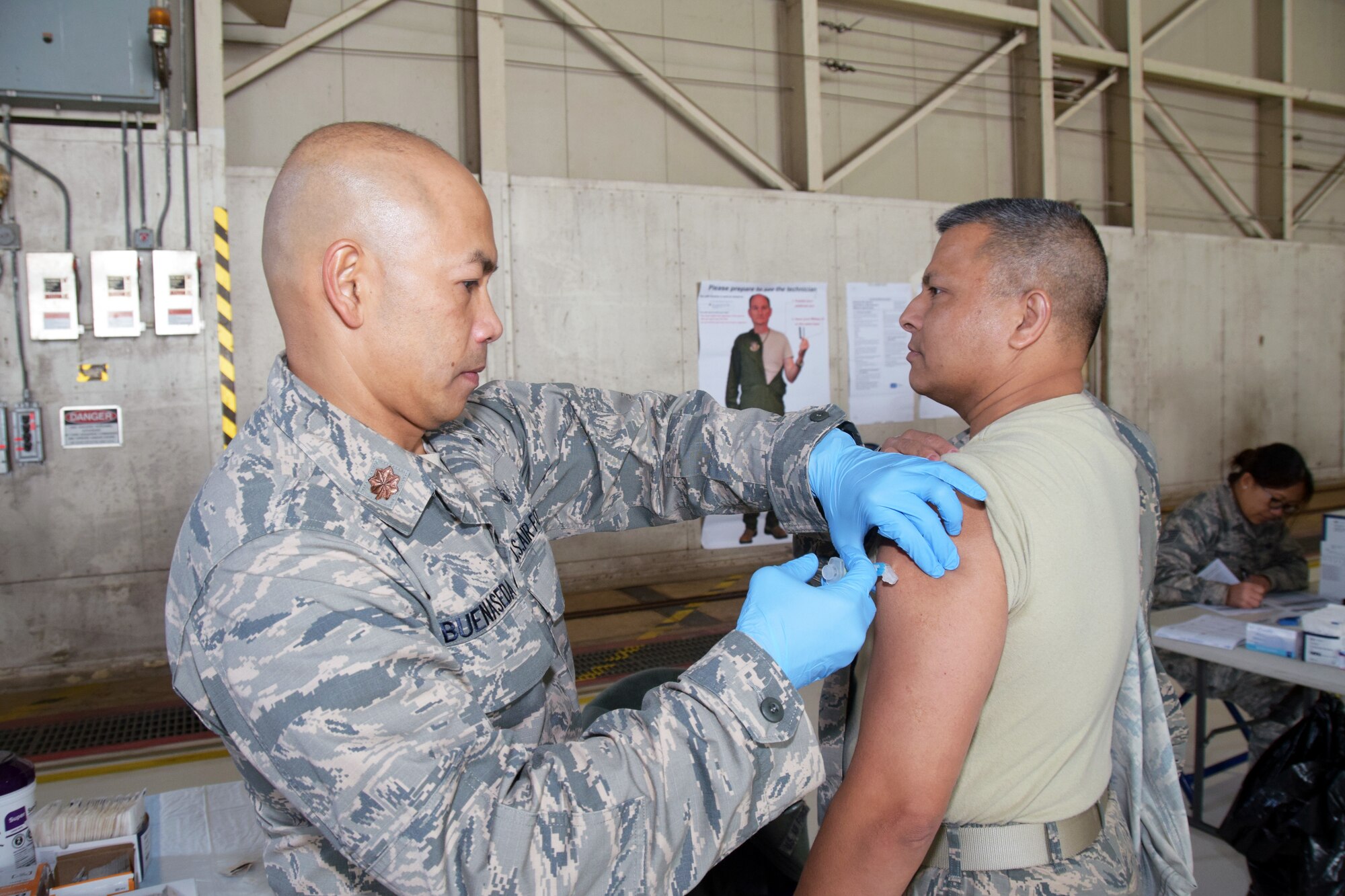 Maj. Jerry O. Buenaseda, 433rd Aerospace Medicine Squadron clinical nurse, injects an influenza vaccination into the arm of Chief Master Sgt. Vishal M. Rose, 74th Aerial Port Squadron superintendent of operations Nov. 17, 2018 at Joint Base San Antonio-Lackland, Texas.