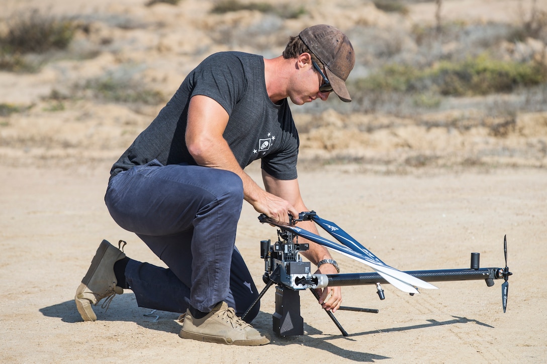 Scott Sanders, head of operations for Anduril Industries, prepares a Lattice Modular Heli-Drone for a test flight at the Red Beach training area, Marine Corps Base Camp Pendleton, California, Nov. 8, 2018. The Lattice Modular Heli-Drone was being tested to demonstrate its capabilities and potential for increasing security. (U.S. Marine Corps photo by Cpl. Dylan Chagnon)