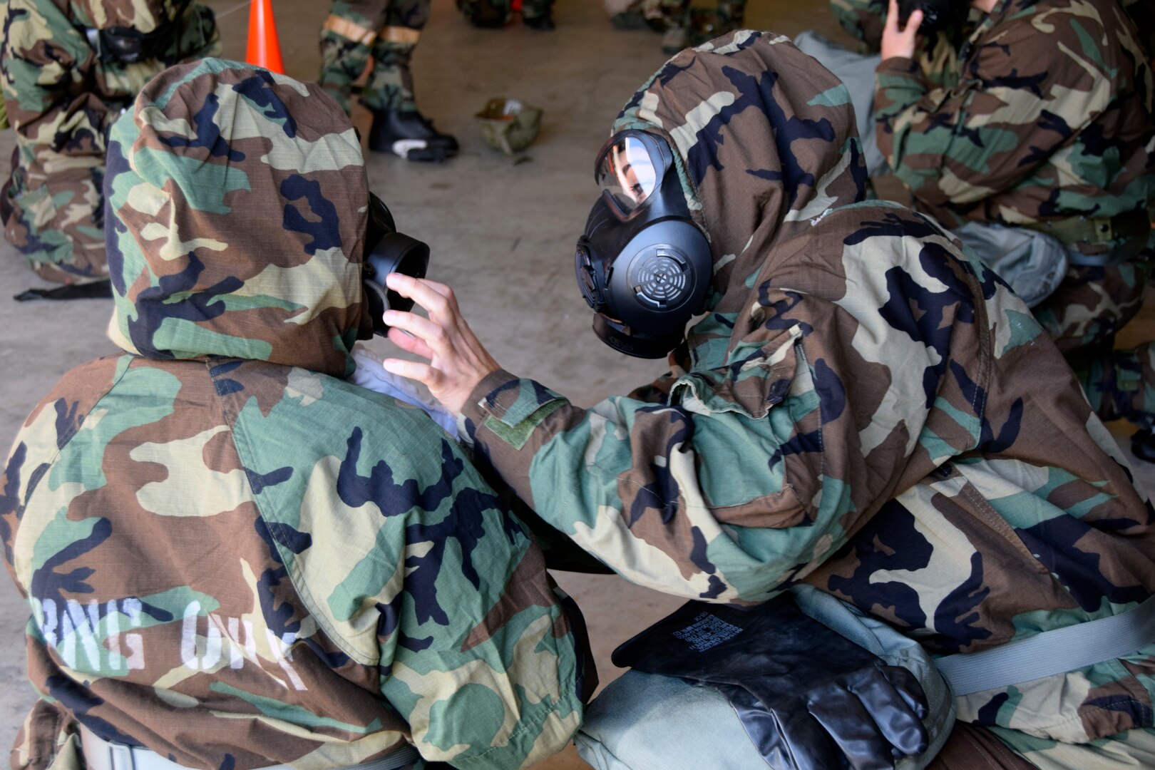 A 433rd Airlift Wing Airman inspects her Wingman’s mask and hood to ensure they are worn properly during a wing-wide readiness exercise at Joint Base San Antonio-Lackland, Texas Nov. 17, 2018.