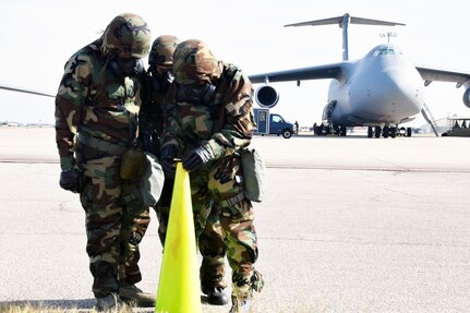 Three 433rd Airlift Wing Reserve Citizen Airmen inspect simulated M8 chemical detection paper during a wing-wide readiness exercise at Joint Base San Antonio-Lackland, Texas Nov. 17, 2018.