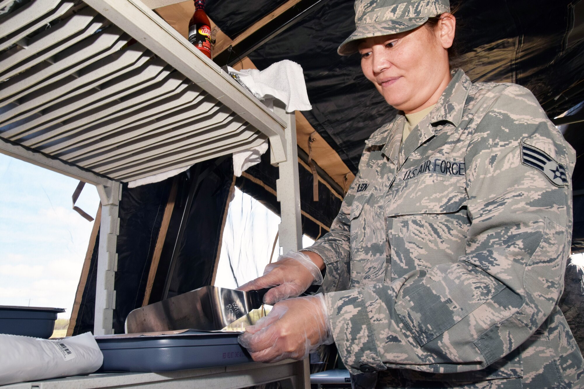 Senior Airman Beatrice V. Chilson, 433rd Force Support Squadron food service specialist, prepares red velvet cake in a single pallet expeditionary kitchen during a wing-wide readiness exercise at Joint Base San Antonio-Lackland, Texas Nov. 17, 2018.