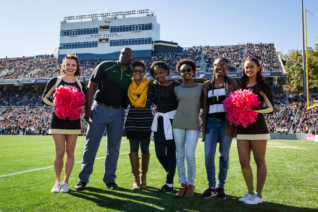 Family poses at sporting event.