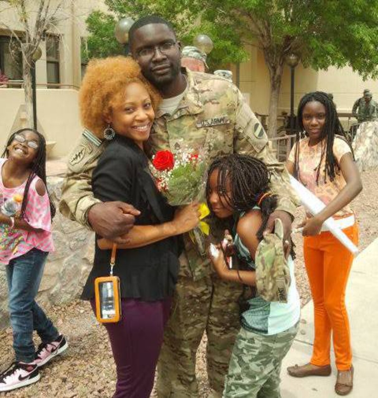 Soldier and family hug.