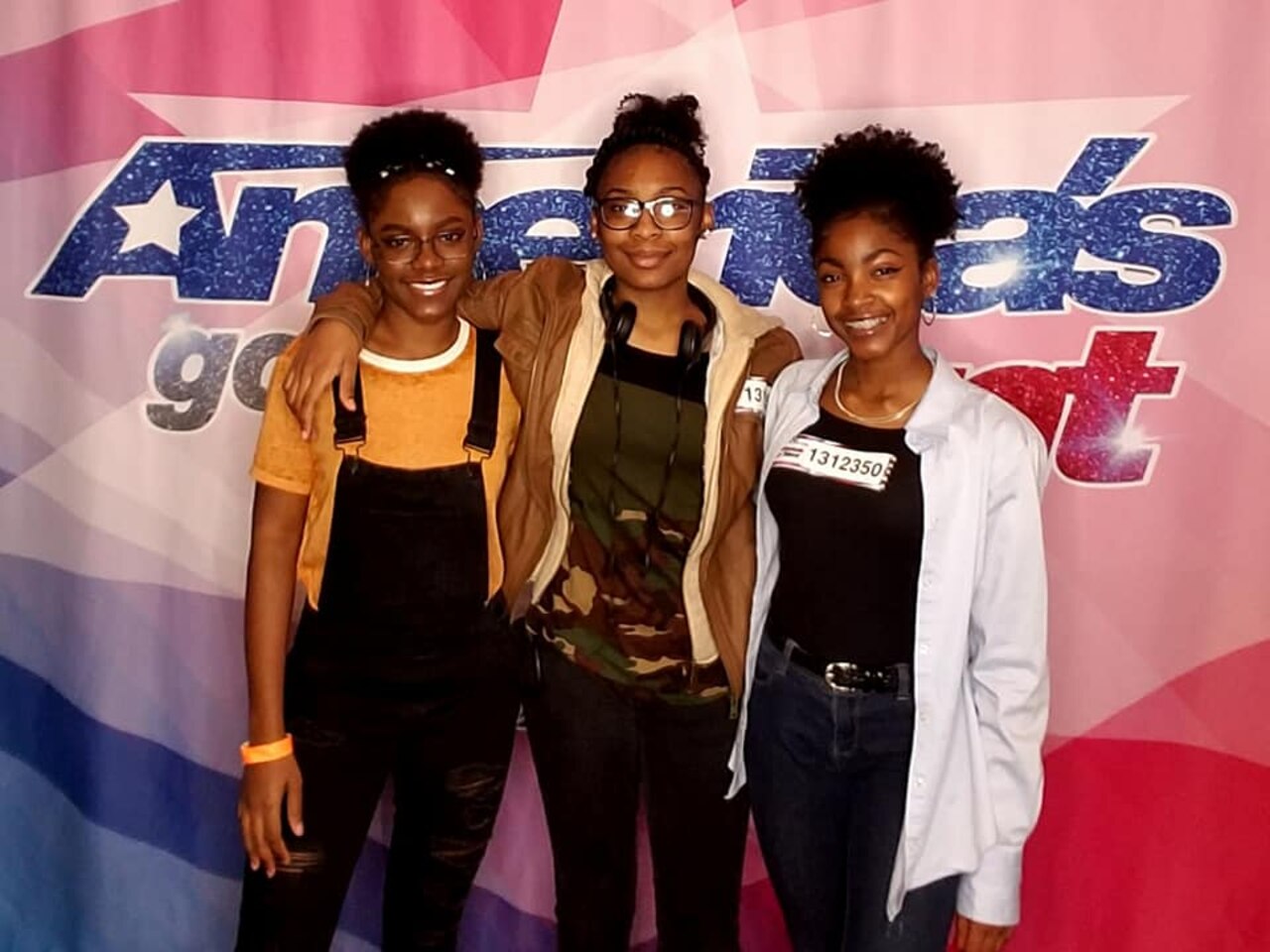 Three young ladies pose for photo at an America’s Got Talent event.