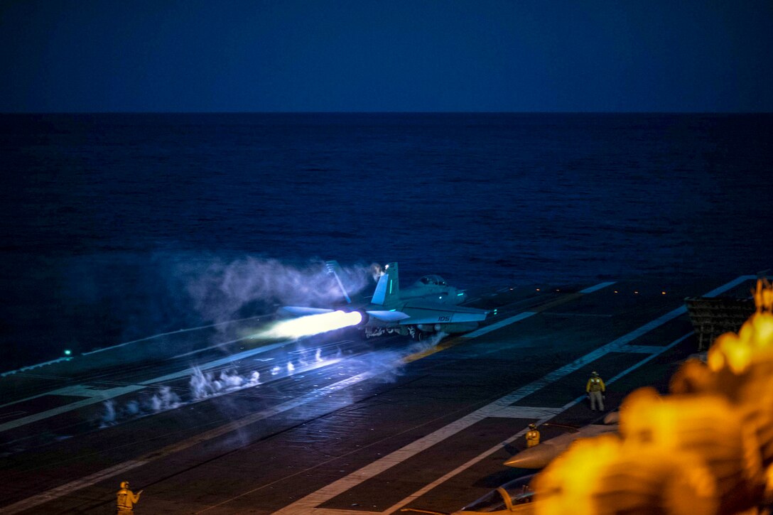 An aircraft takes off from a carrier's flight deck.