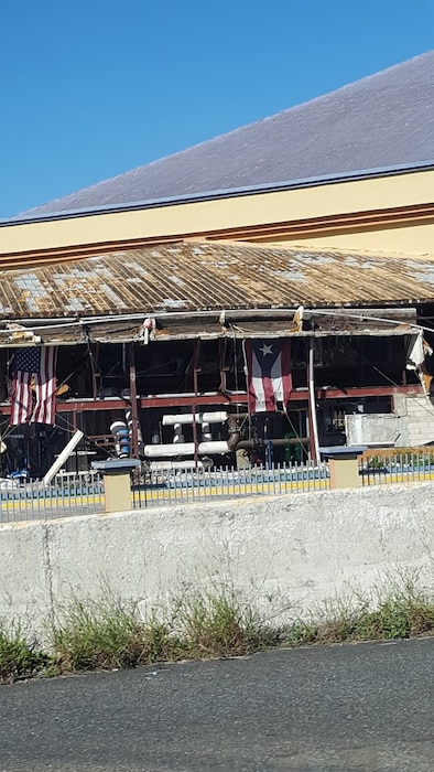 SAN JUAN, Puerto Rico -- Despite being battered by Hurricane Maria, this building still flies the U.S. and Puerto Rico flags, Nov. 4, 2017. Photo by Shannon Silva. This was a 2018 photo drive entry.