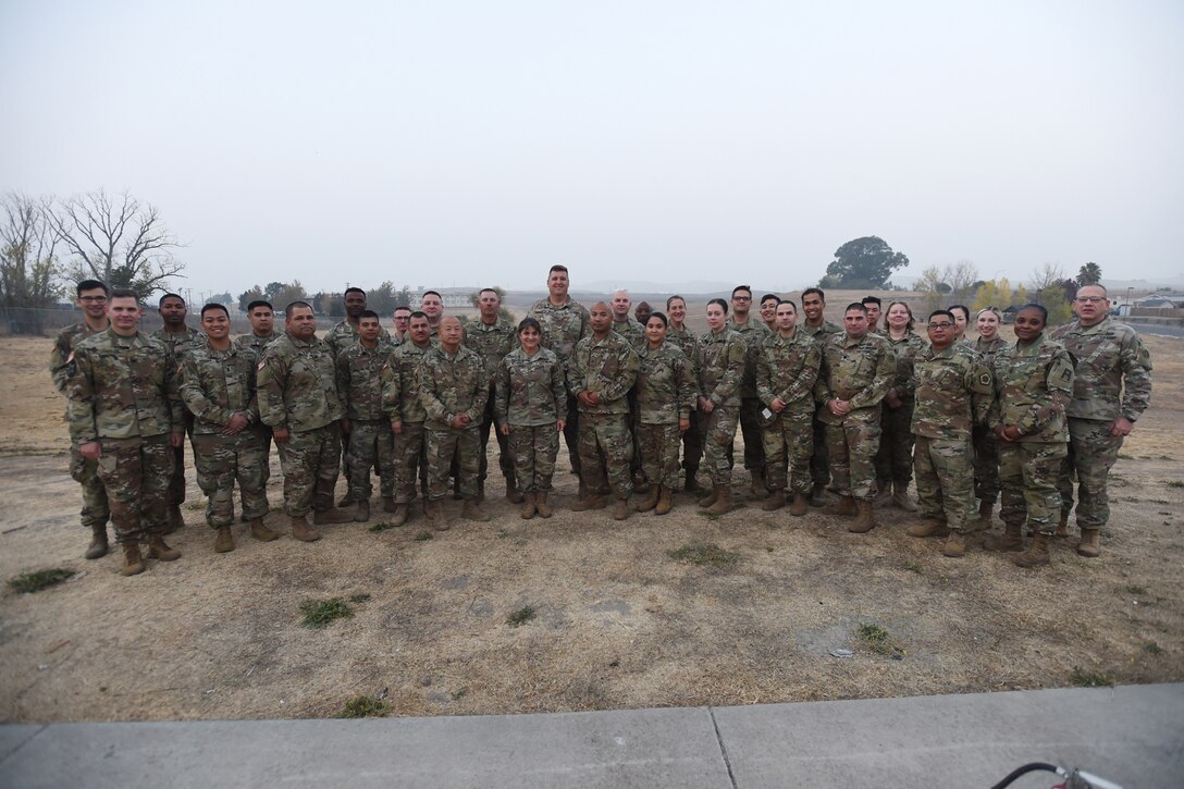 Brig. Gen. Kris A. Belanger, center, commanding general of the 85th United States Army Reserve Support Command, pauses for a photo with Army Reserve Soldiers assigned to the 2-360th Training Support Battalion, 85th Support Command, at Parks Reserve Forces Training Area, Nov. 17, 2018.