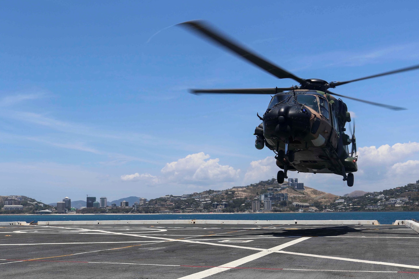 PORT MORESBY, Papua New Guinea (Nov. 16, 2018) A Royal Australian Navy helicopter, assigned to HMAS Adelaide (L01), lands on the flight deck of the amphibious transport dock ship USS Green Bay (LPD 20). Green Bay is in Port Moresby to assist with security efforts ahead of the Asia-Pacific Economic Cooperation (APEC) conference and is the second U.S. ship to visit Port Moresby in the last two months. Green Bay is part of Amphibious Squadron 11 and is operating in the region to enhance interoperability with partners and serve as a ready-response force for any type of contingency.