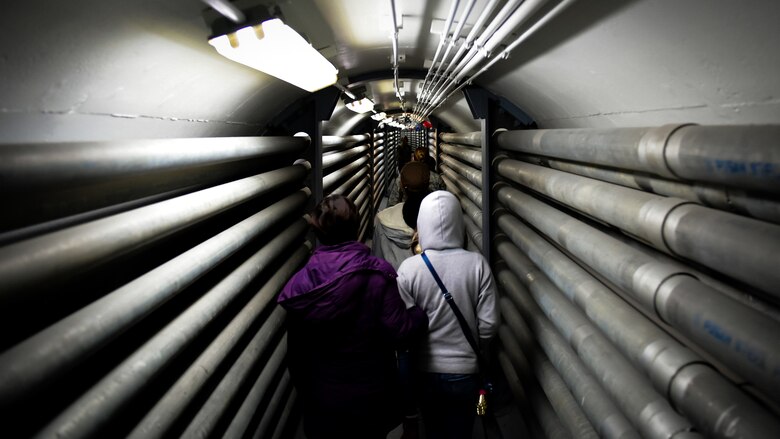 Families of 694th Air and Space Operations Center walk through an underground hallway during a tour of the ISRG and Korean Combined Operations and Intelligence Center on Osan Air Base, Nov. 16, 2018.