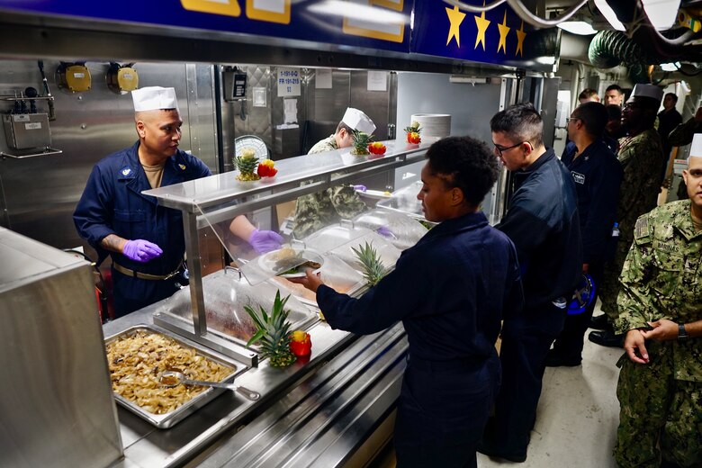 181119-N-KP021-0001 YOKOSUKA, Japan (Nov. 19, 2018) Sailors aboard the Arleigh Burke-class guided-missile cruiser USS John S. McCain (DDG 56) serve and receive food on the newly opened Maverick Café aboard the ship's mess decks. John S. McCain is forward-deployed to the U.S. 7th Fleet area of operations in support of security and stability in the Indo-Pacific region. (U.S. Navy photo by Lt. j.g. Julius Young)