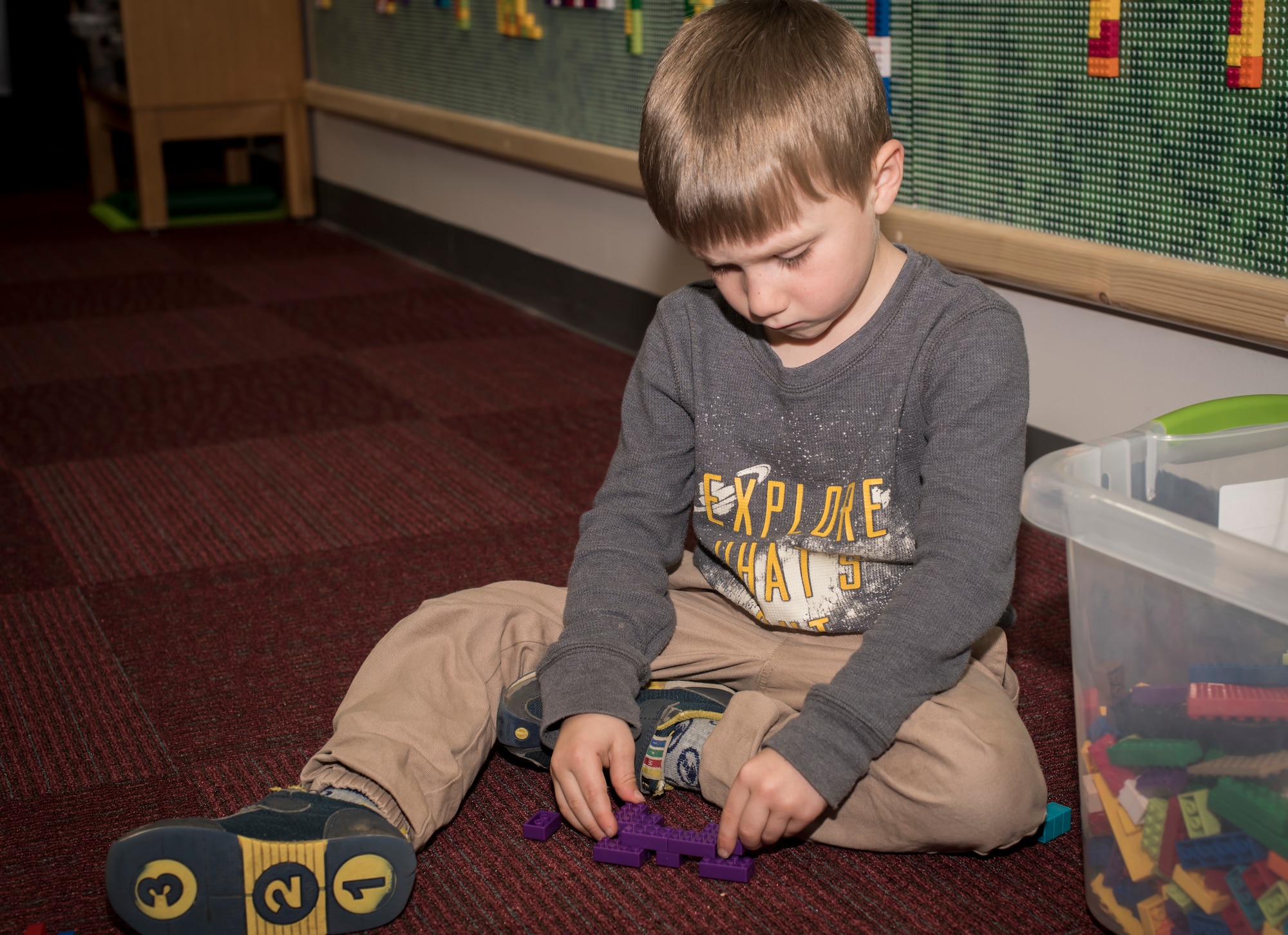 Young boy builds with blocks