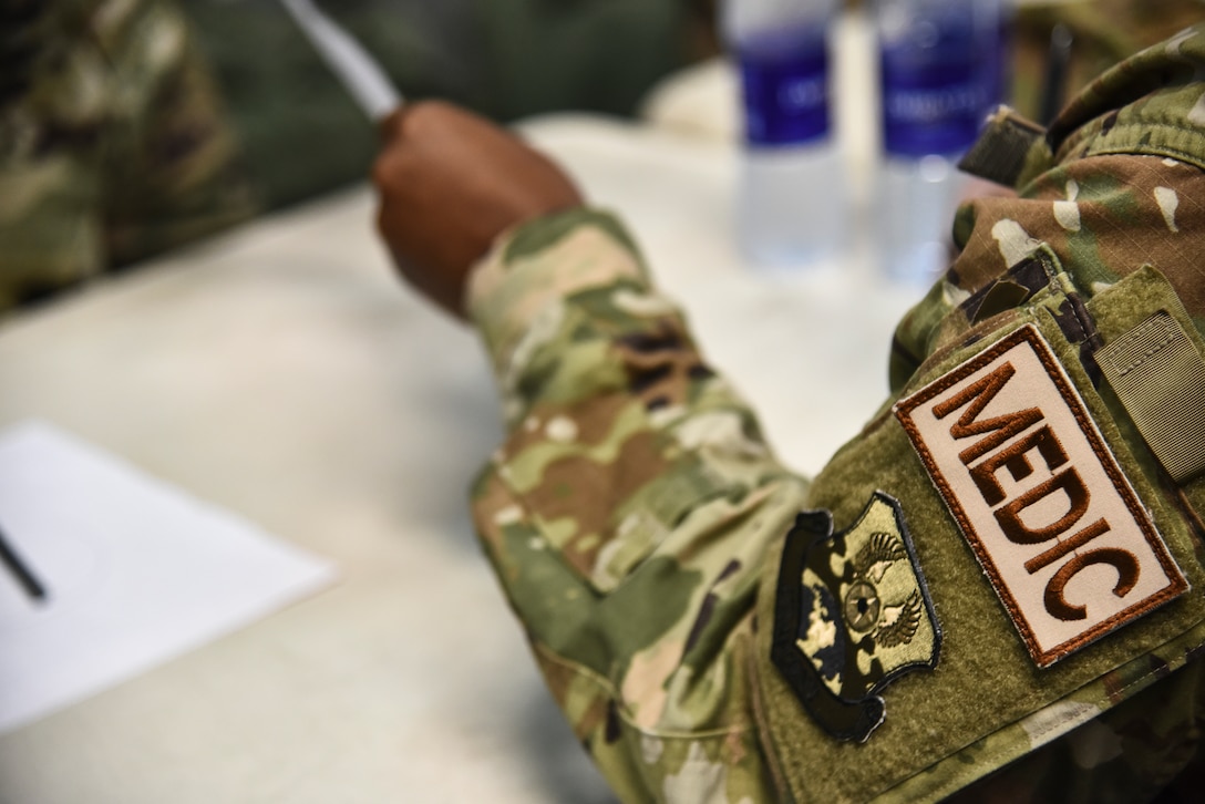A U.S. Airman assigned to the 380th Expeditionary Medical Group processes Airmen during an Individual Protection Equipment readiness exercise at Al Dhafra Air Base, United Arab Emirates, Nov. 9, 2018. The objective of the exercise was to evaluate the 380th Air Expeditionary Wing’s ability to rapidly equip members with Chemical, Biological, Radiological and Nuclear defense equipment, as well as Biological and Chemical Warfare kits. (U.S. Air Force photo by Senior Airman Mya M. Crosby)