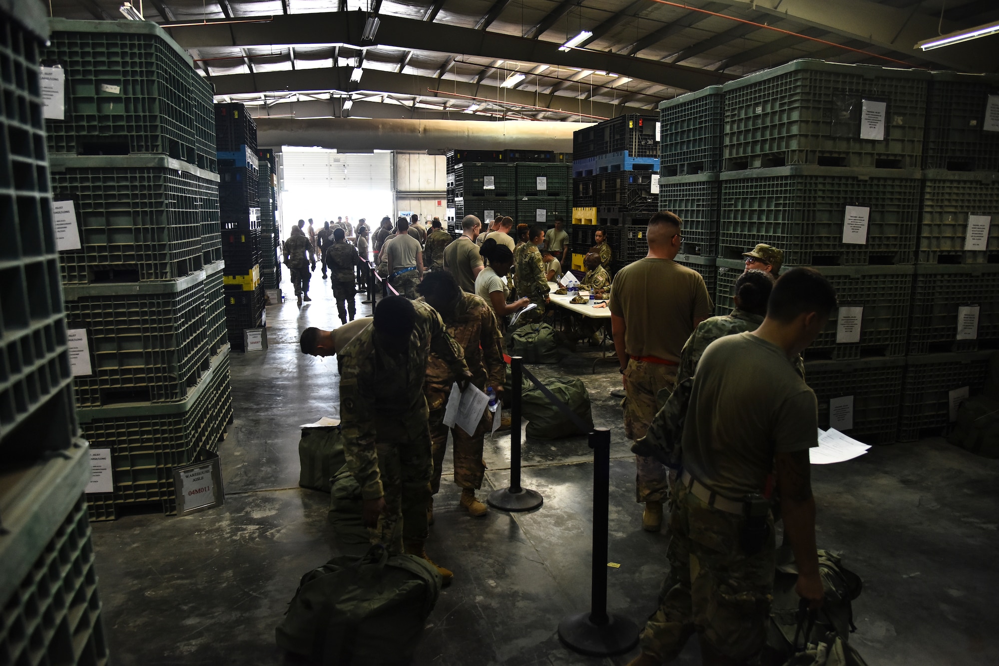 U.S. Airmen assigned to the 380th Air Expeditionary Wing wait in line to get equipment processed during Individual Protection Equipment readiness exercise at Al Dhafra Air Base, United Arab Emirates, Nov. 9, 2018. The 380th AEW Inspector General team, 380th Expeditionary Logistics Readiness Squadron, and 380th Expeditionary Medical Group teamed up to put ADAB’s readiness to the test by pushing personnel out the door with their gear as quickly as possible. (U.S. Air Force photo by Senior Airman Mya M. Crosby)
