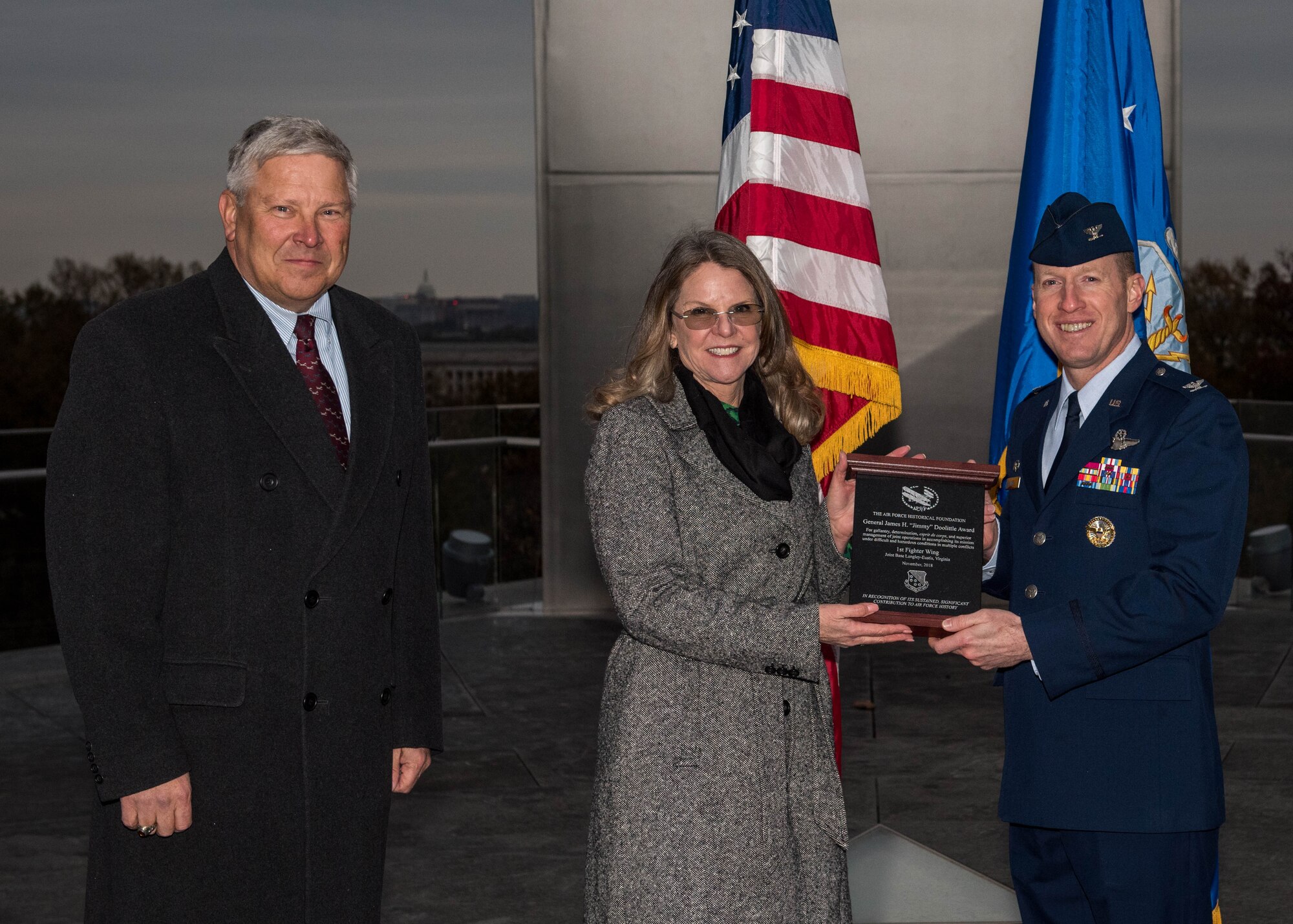Retired U.S. Air Force Lt. Gen. Christopher Miller, Air Force Historical Foundation president and Jonna Doolittle Hoppes, Doolittle Foundation executive director and granddaughter of Gen. James H. “Jimmy” Doolittle presents an award to U.S Air Force Col. Jason Hinds, 1st Fighter Wing commander, at the Air Force Memorial in Arlington, Virginia, Nov. 13, 2018.