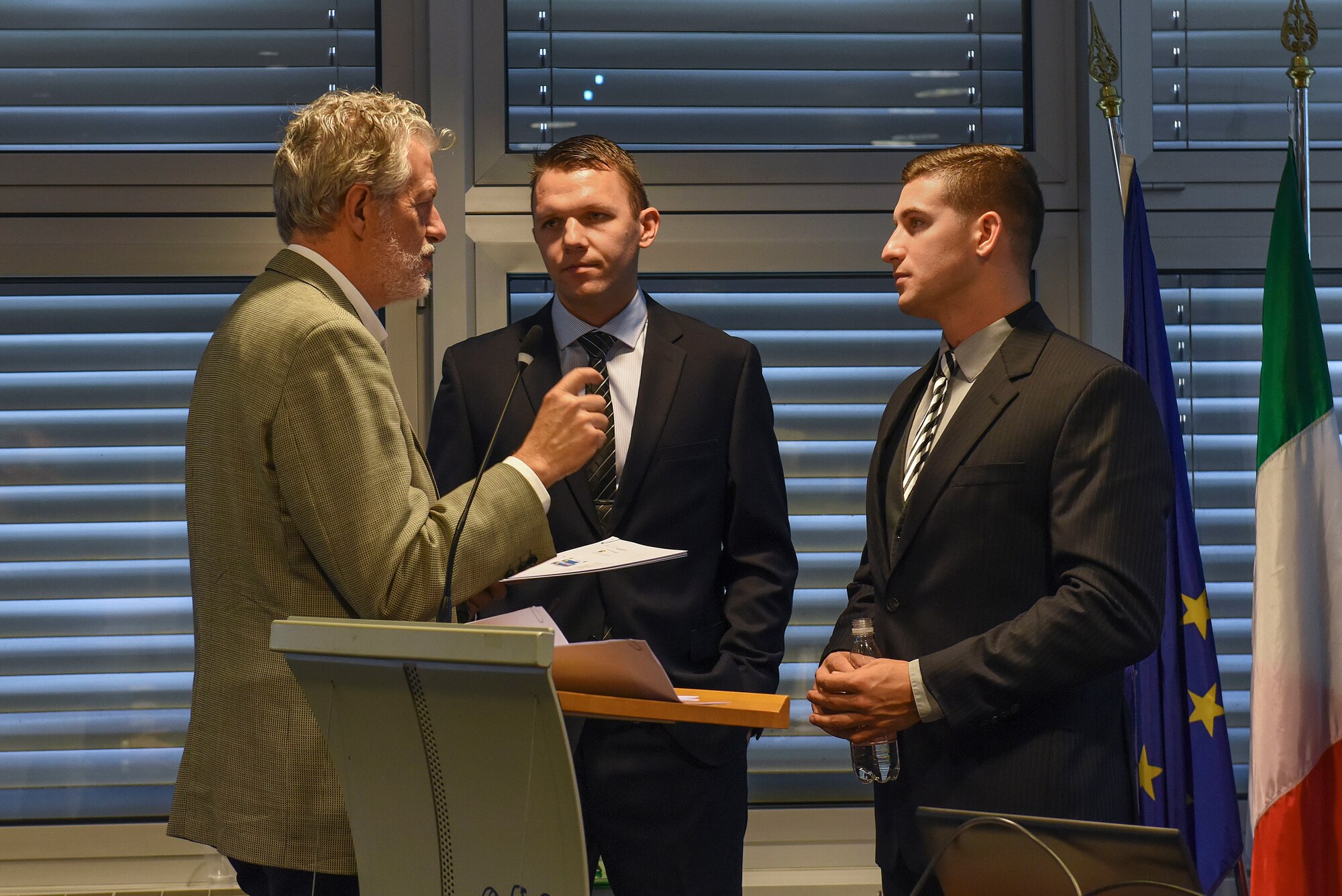 U.S. Air Force Staff Sgt. Michael Stoermer, 31st Contracting Squadron contract manager, right, and U.S. Air Force 2nd Lt. Oleksandr Bakuta, 31 CONS contract manager, center, speak with an Italian contractor during the Industry Day conference in Pordenone, Italy, Nov. 9, 2018. The conference was an opportunity for the 31 CONS to develop a better working relationship with local businesses, as well as offer more information to these businesses about working on the installation.