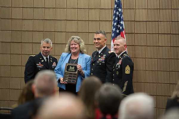 Lt. Gen. Todd T. Semonite (left)  and Sgt. Maj. Bradley J Houston (right) presents Cherie Kunze and Col. Patrick Kinsman with an award for being the seventh best district throughout the U.S. Army Corps of Engineers for awarding contracts to Service Disabled Veteran Owned Small Businesses.