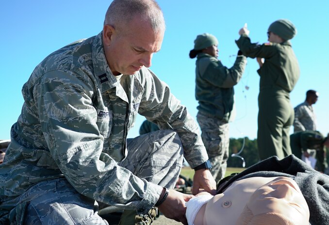 Air Force Reserve Capt. Shawn Griffin, 315th Aeromedical Evacuation Squadron flight nurse, examines a simulated battlefield patient during an operational readiness exercise at North Auxiliary Airfield, S.C., Nov. 17, 2018. The exercise provided the 315th Operations Group with hands-on training in a variety of airlift and aeromedical evacuation tactics during simulated combat events. (U.S. Air Force photo by Staff Sgt. Andrew Fox)