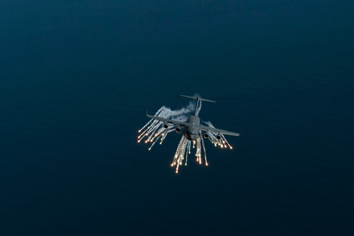 A C-17 Globemaster III aircraft assigned to 315th Airlift Wing out of Joint Base Charleston, S.C., deploys flares as part of an operational readiness exercise Nov. 17, 2018. The exercise provided the 315th Operations Group with hands-on training in a variety of airlift and aeromedical evacuation tactics during simulated combat events. (U.S. Air Force photo by Staff Sgt. Nicholas A. Priest)